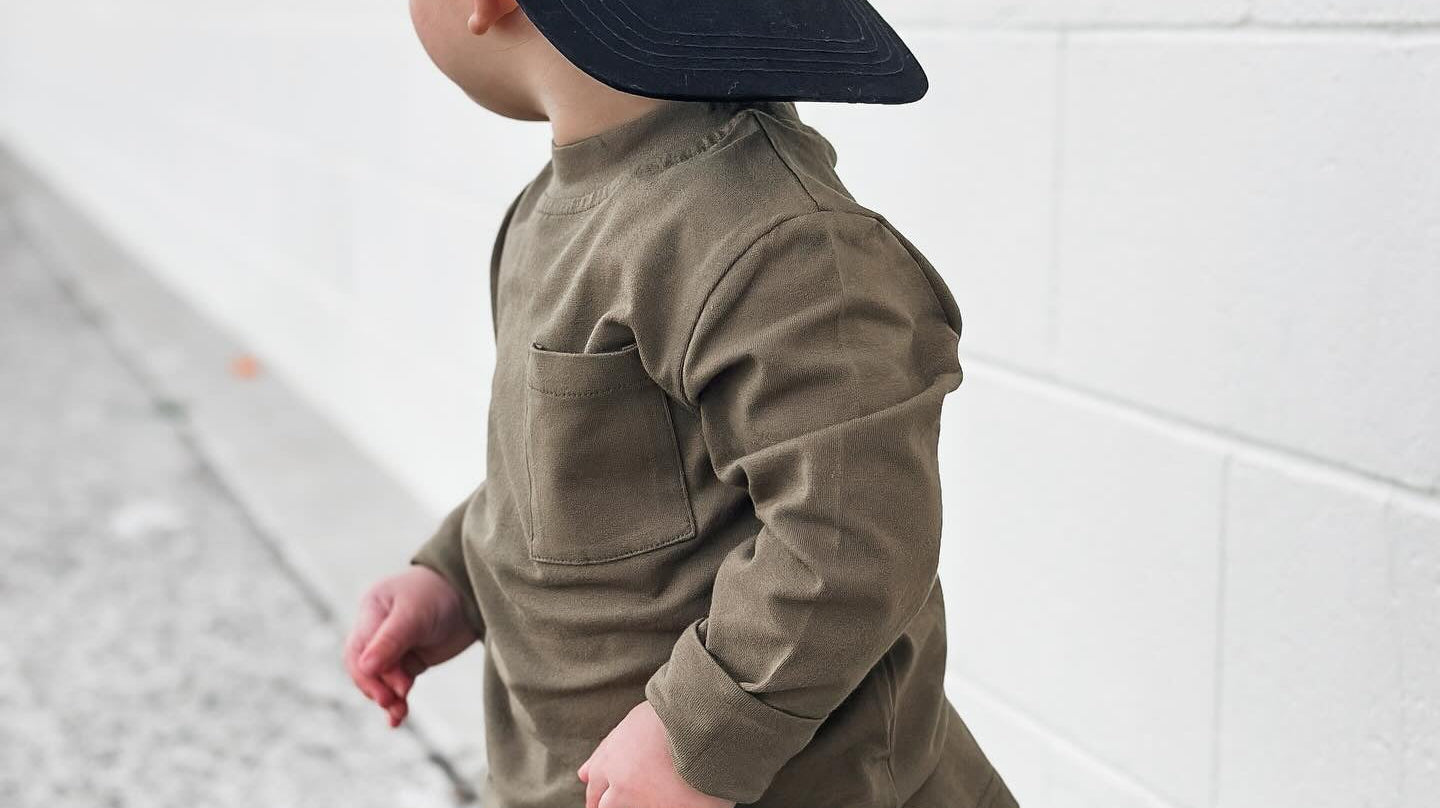 Toddler Hat design in daybreak pattern wore by a toddler with brown shirt and black pajamas