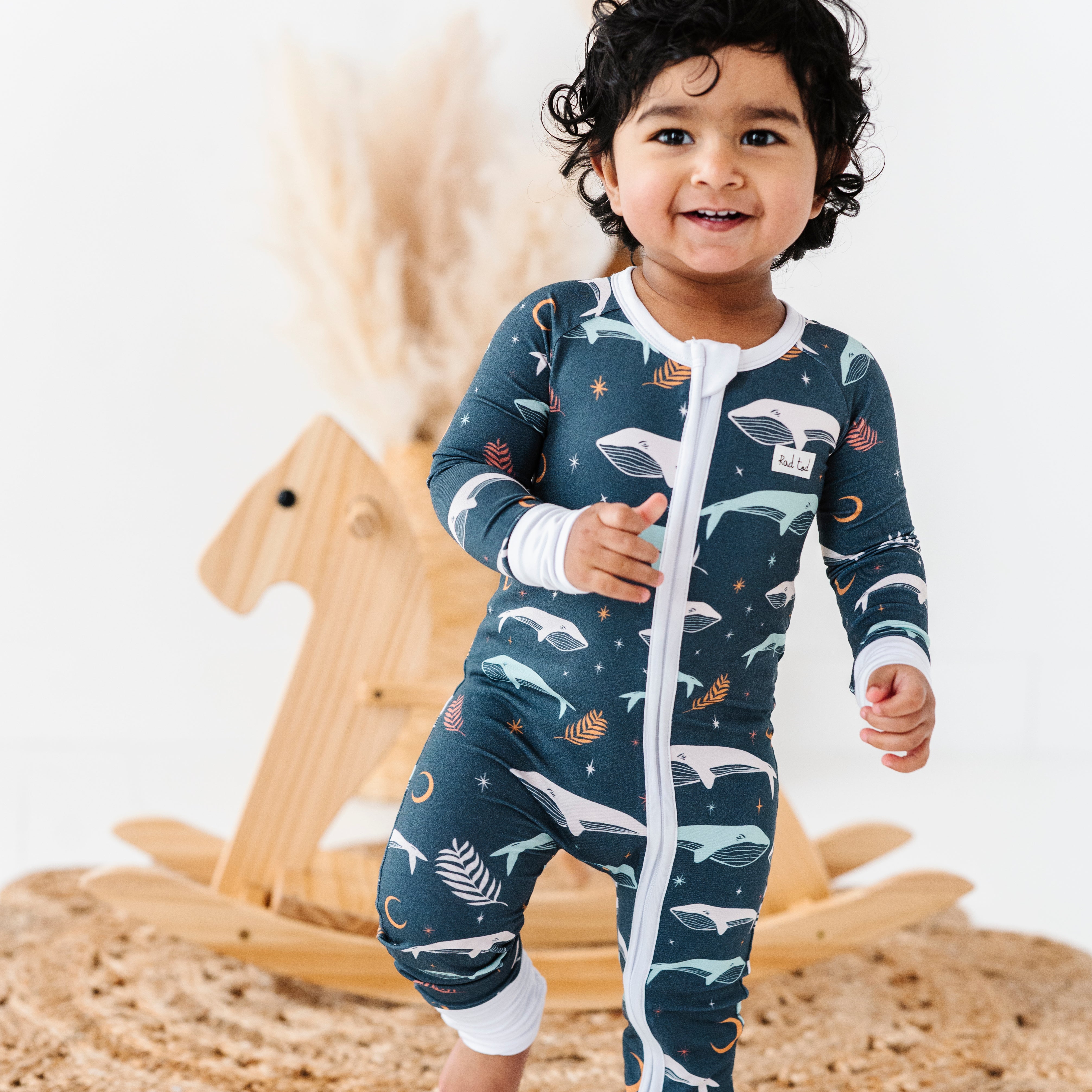 Luna Whale Bamboo Onesie featuring soft, breathable fabric, hypoallergenic properties, and a cute whale design for ultimate comfort and style.