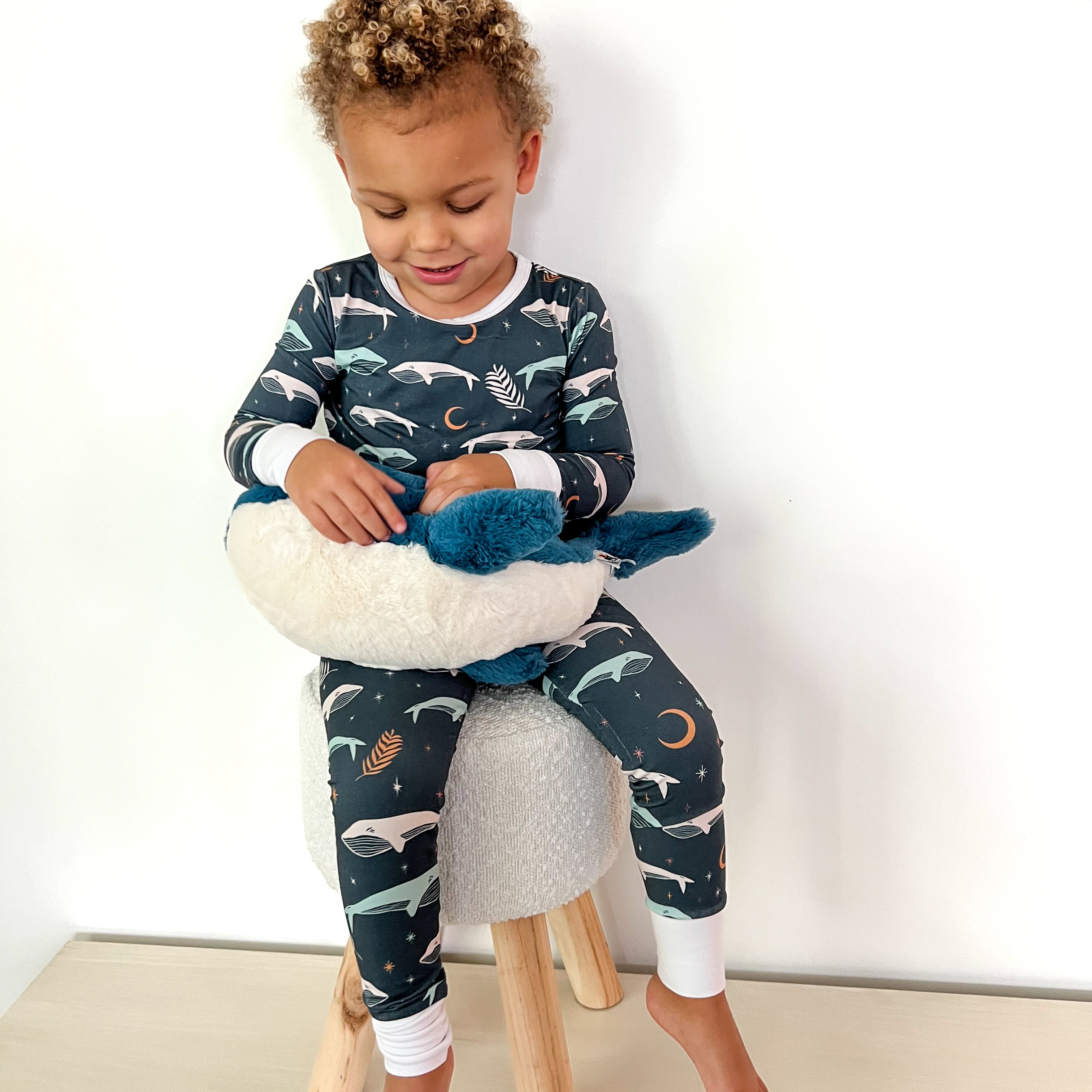 toddler wearing Luna Whale Bamboo Onesie featuring soft, breathable fabric, hypoallergenic properties, and a cute whale design for ultimate comfort and style