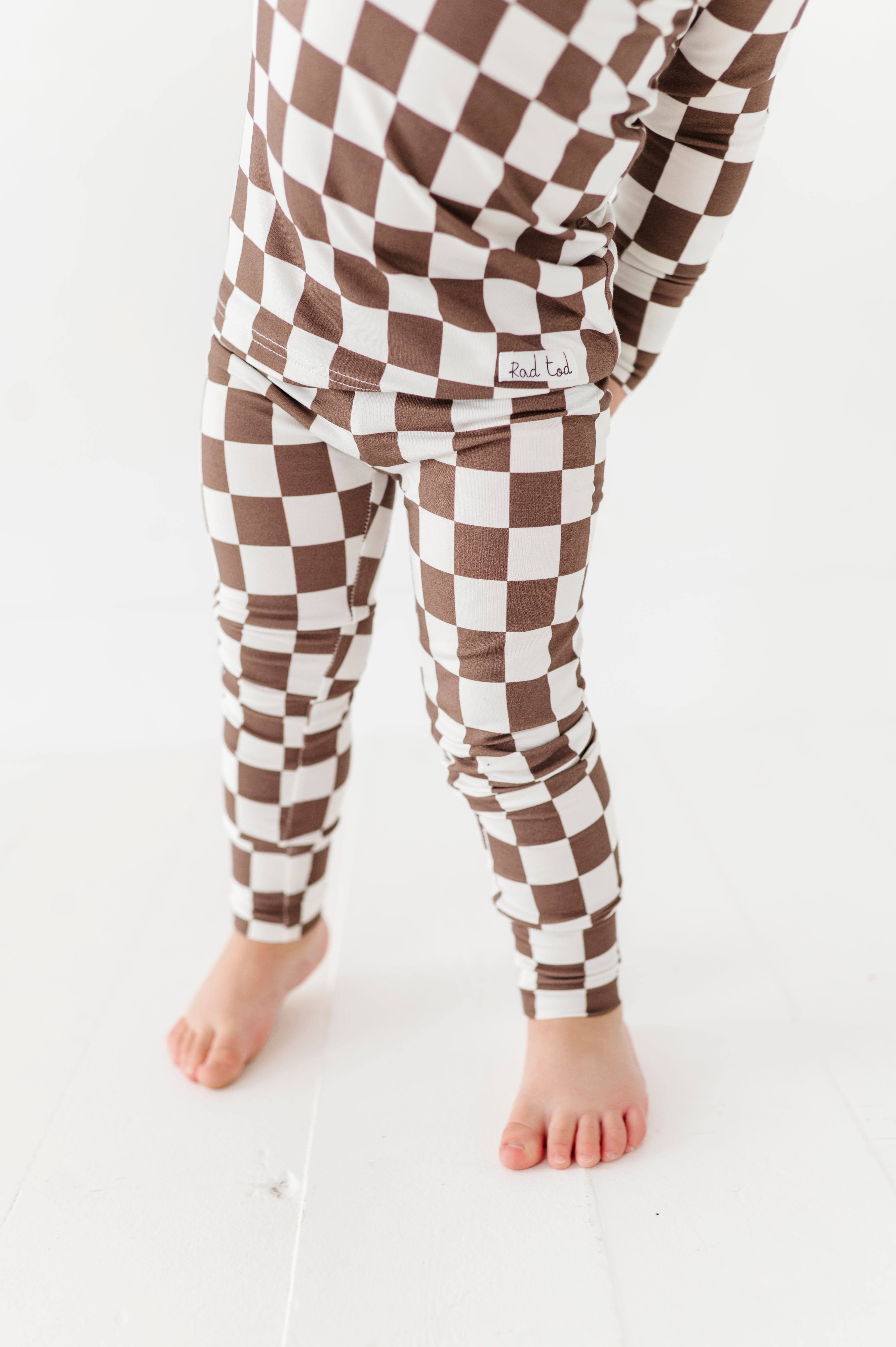 Bronze and white checkered bamboo 2-piece pajama set for toddlers, featuring a short sleeve top and elastic waistband pants by Rad Toddler.