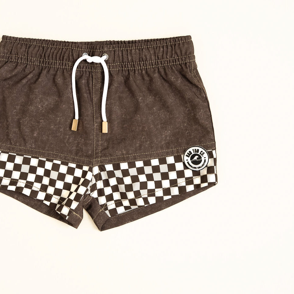 Brown shorts with a checkered pattern and brand logo on a white background