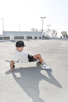 boy skating away wearing a Trendy toddler t-shirt with vibrant designs for comfortable everyday wear