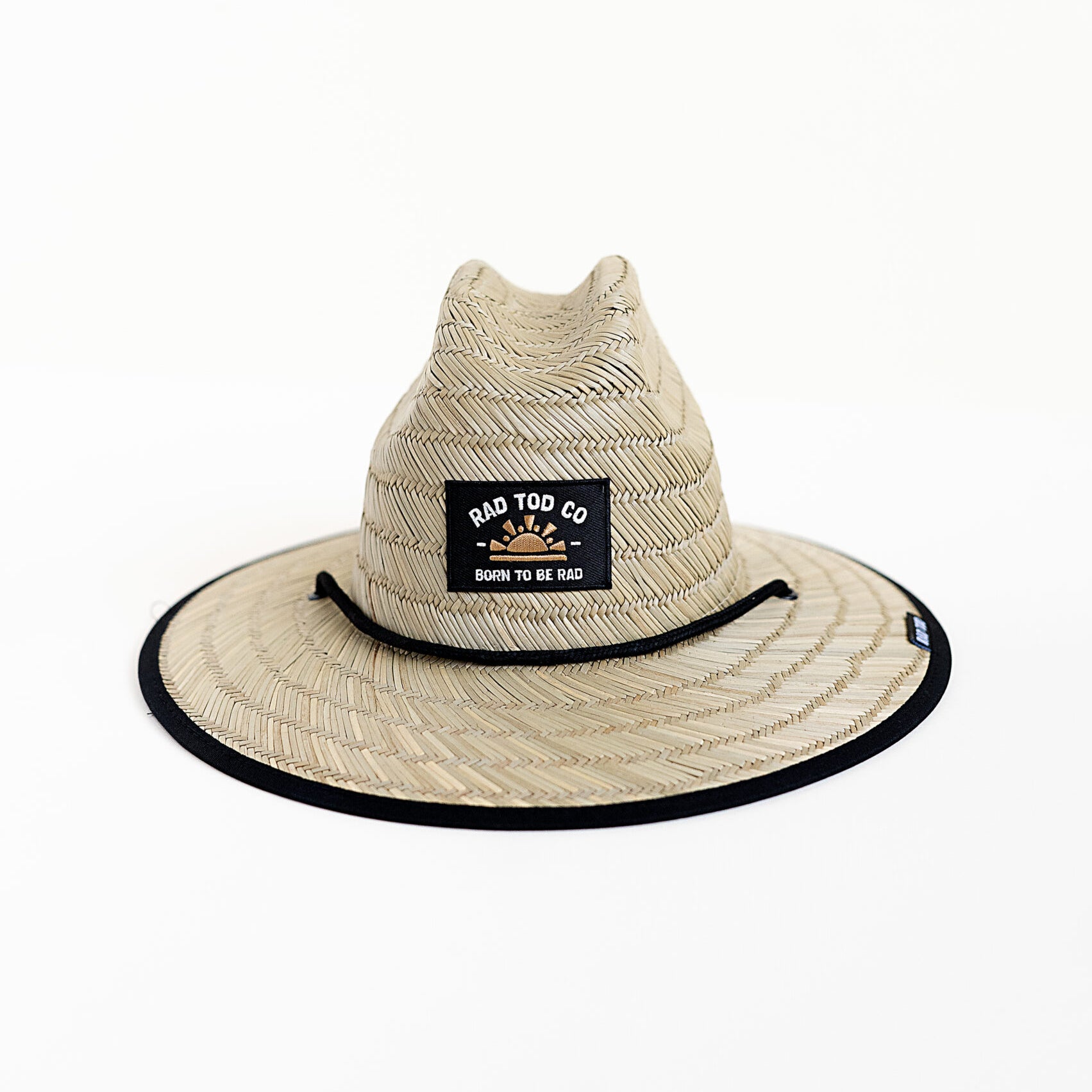 front of RAD TODDLER straw sun hat with coastal dunes pattern featuring orange, forest green, and black colors with palm trees, designed for toddler sun protection