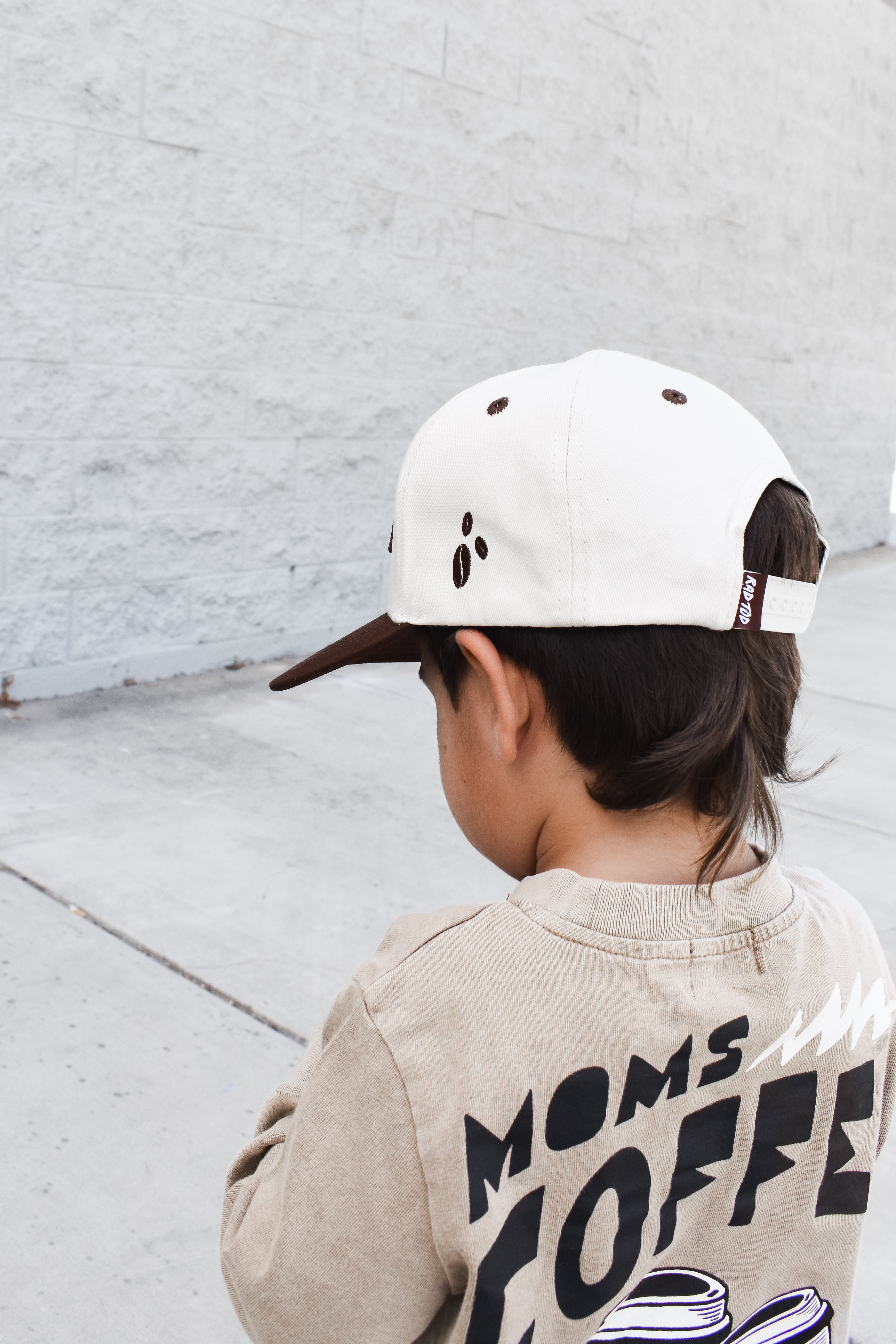 Side view of kids snapback highlighting the small coffee bean patch detail