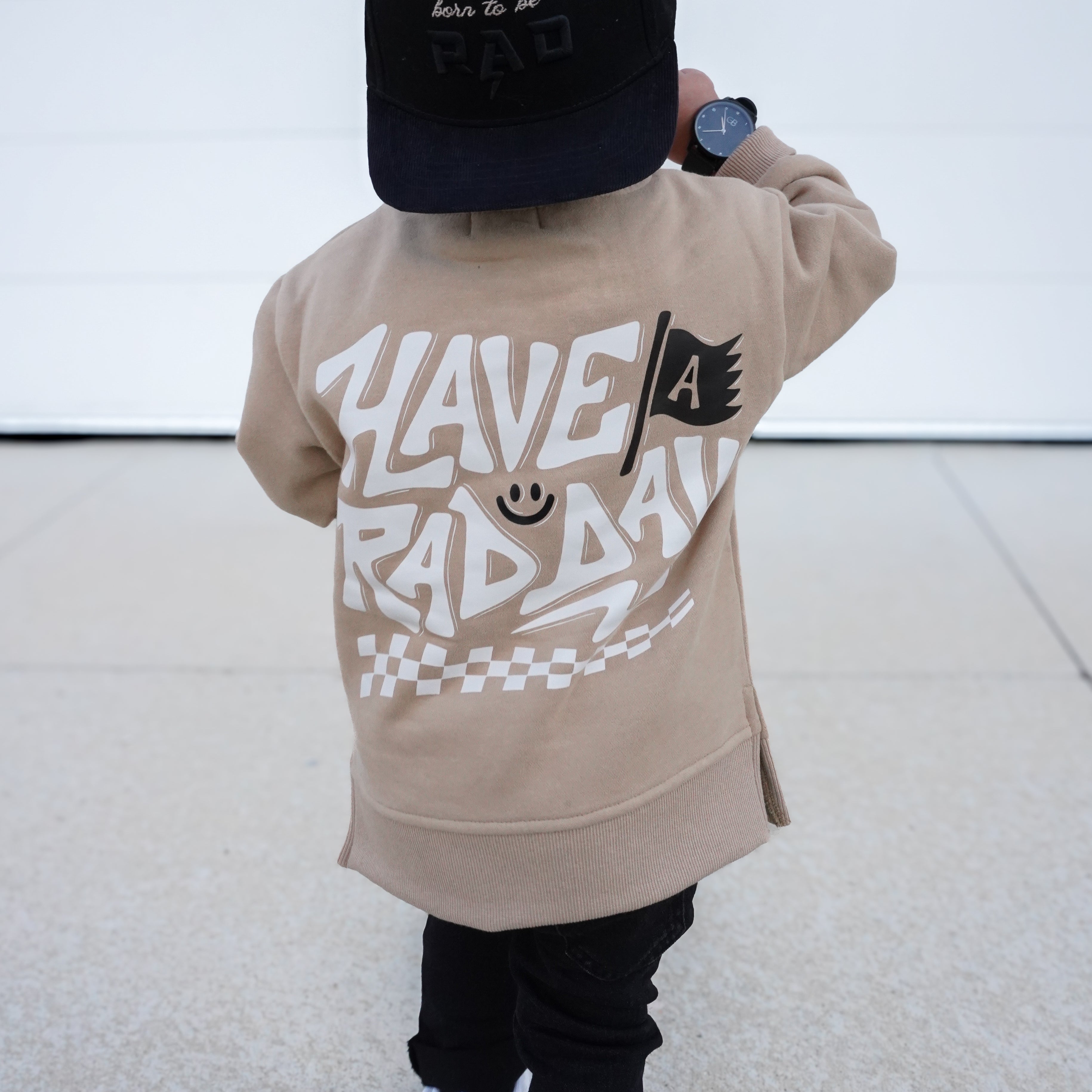 Beige kids crewneck styled casually with everyday outfit, featuring playful graphic details