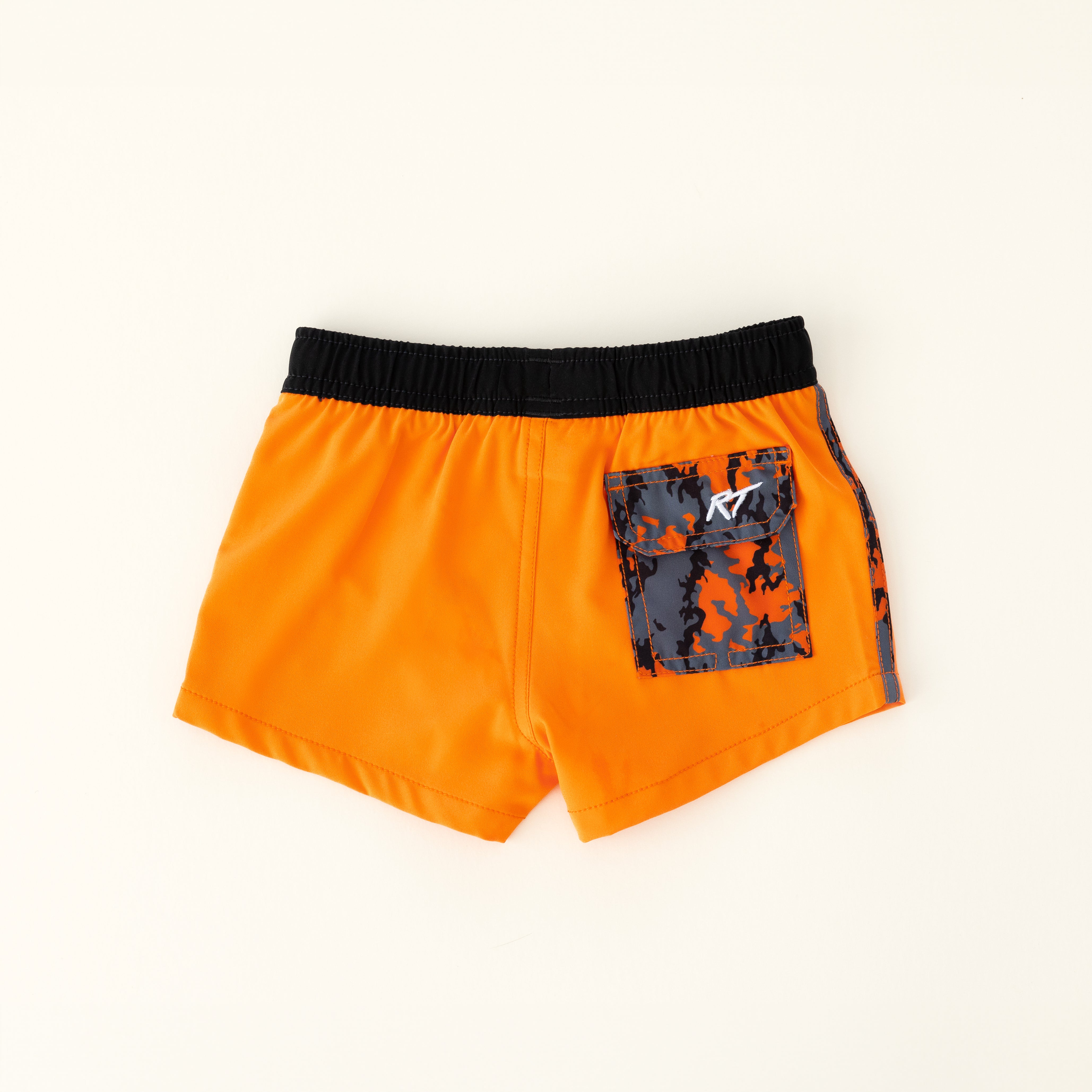 backside of Bright orange swim shorts with an elastic waistband and drawstring, made from quick-drying fabric. Ideal for swimming, beach trips, and outdoor activities. Features vibrant patterns and a comfortable fit for active kids.
