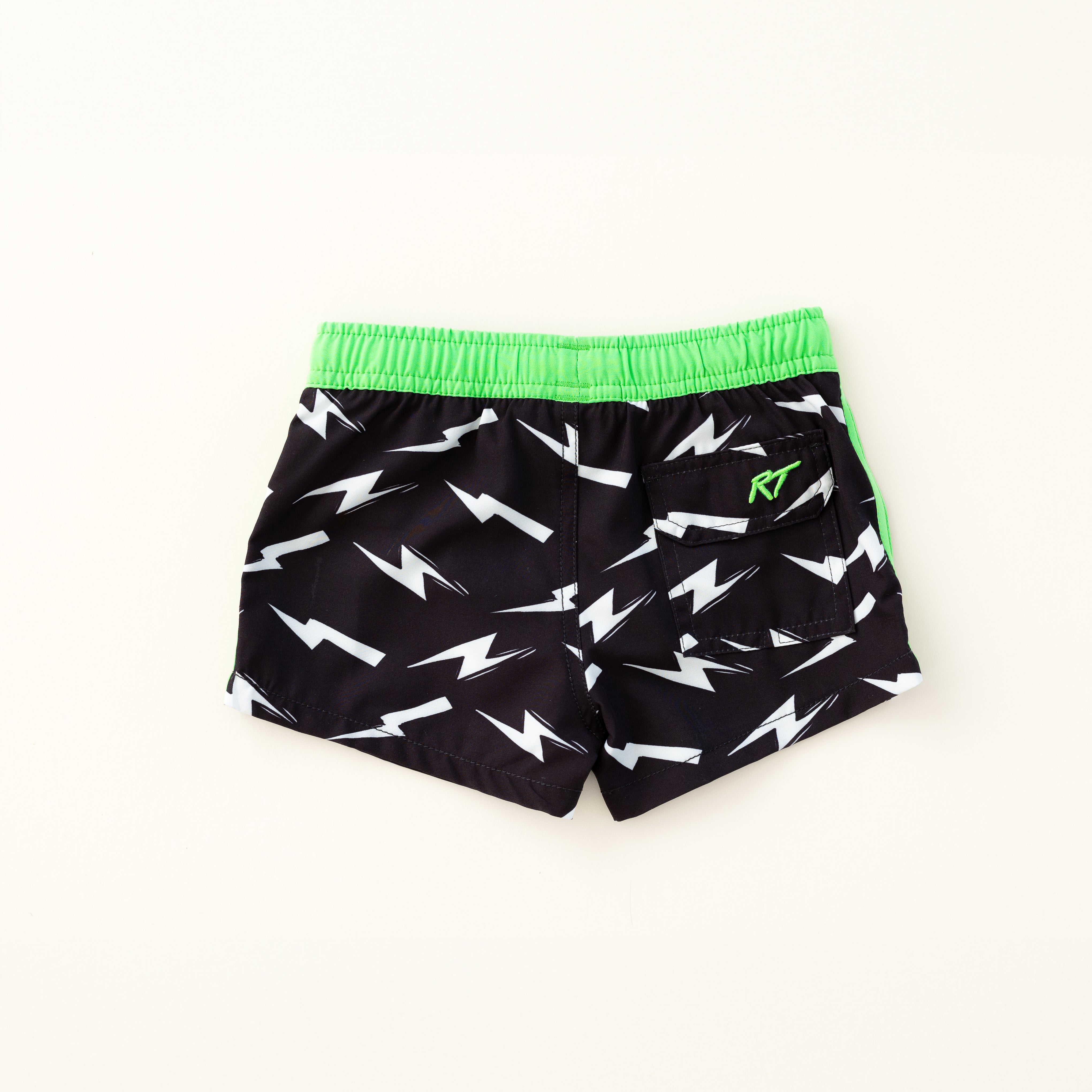 backside of Bright thunderbolt pattern swim shorts with an elastic waistband and drawstring, made from quick-drying fabric. Ideal for swimming, beach trips, and outdoor activities. Features vibrant patterns and a comfortable fit for active kids.