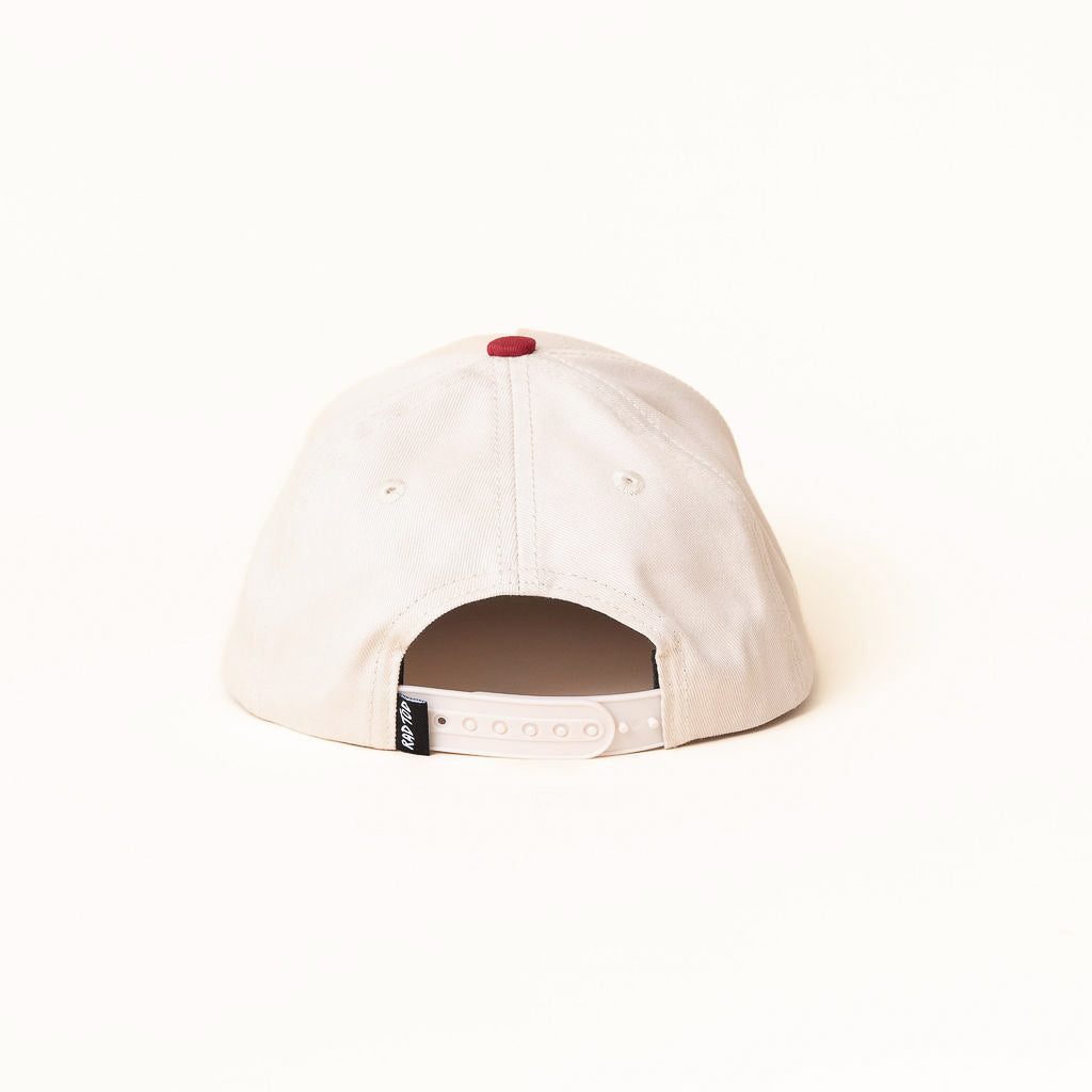 White cap with a red button on a white background