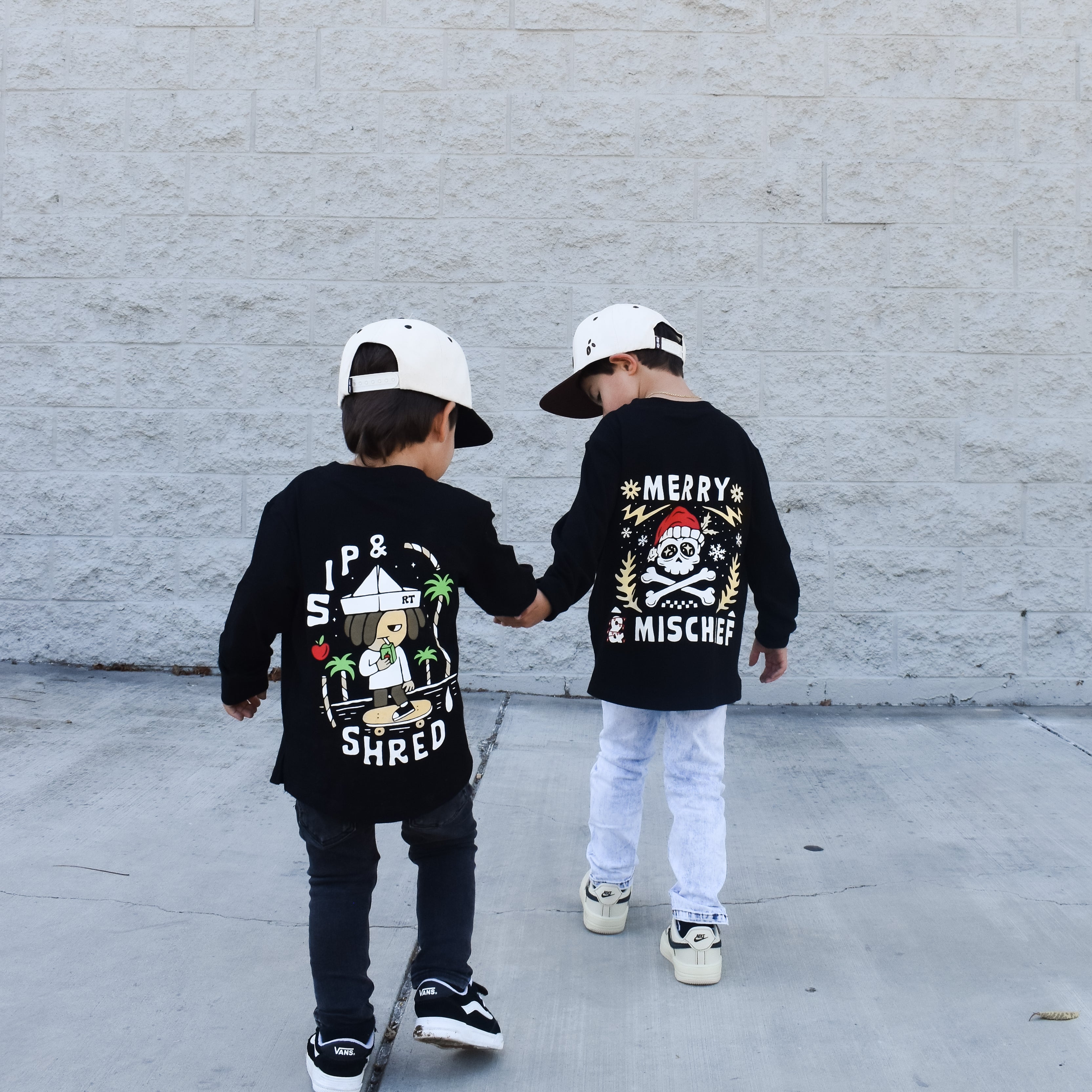 Sip and Shred and Merry and MIschief shirts being worn by two boys