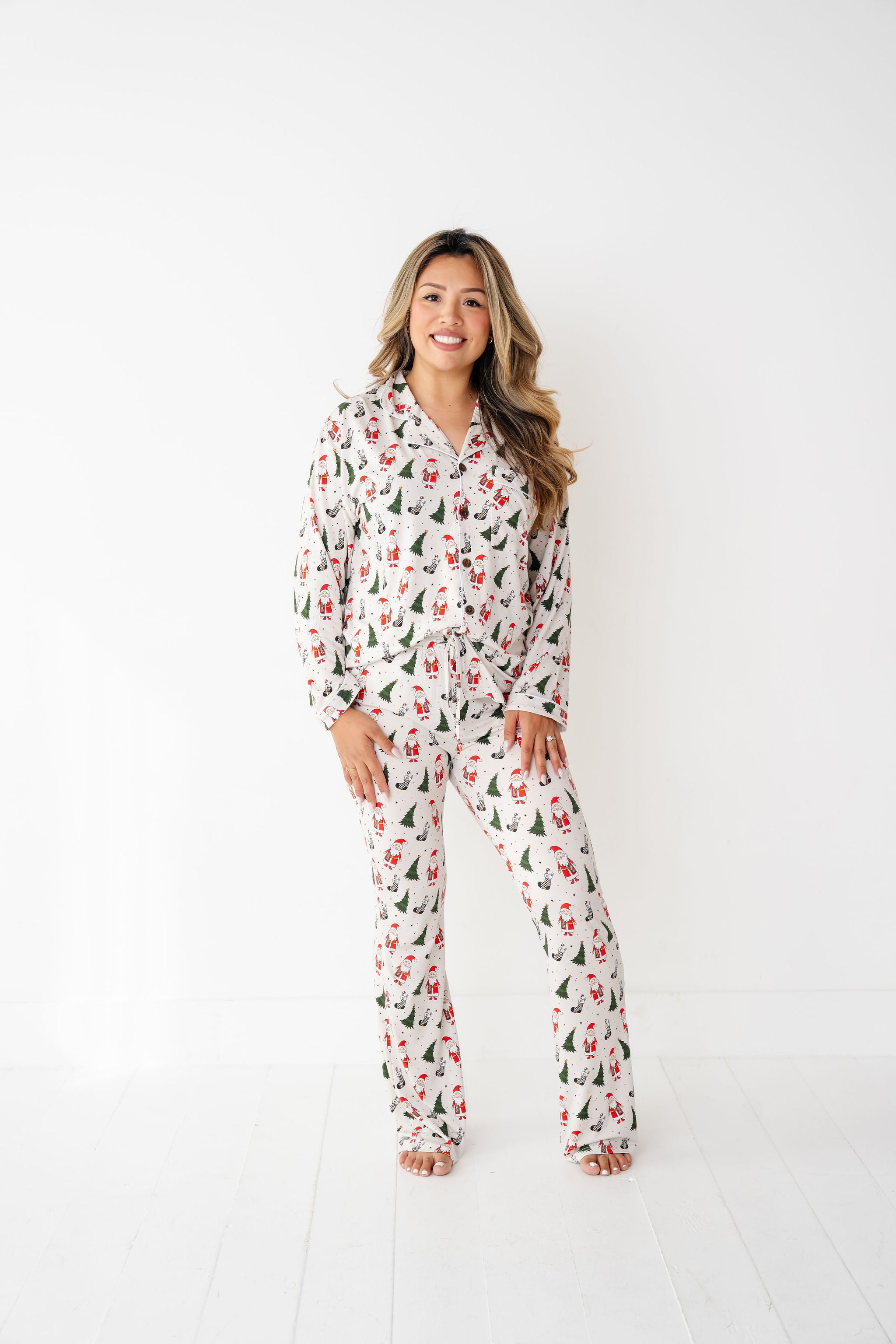 woman wearing RAD TODDLER Merry Everything Bamboo Christmas Pajamas with Santa, trees, and checkered stockings