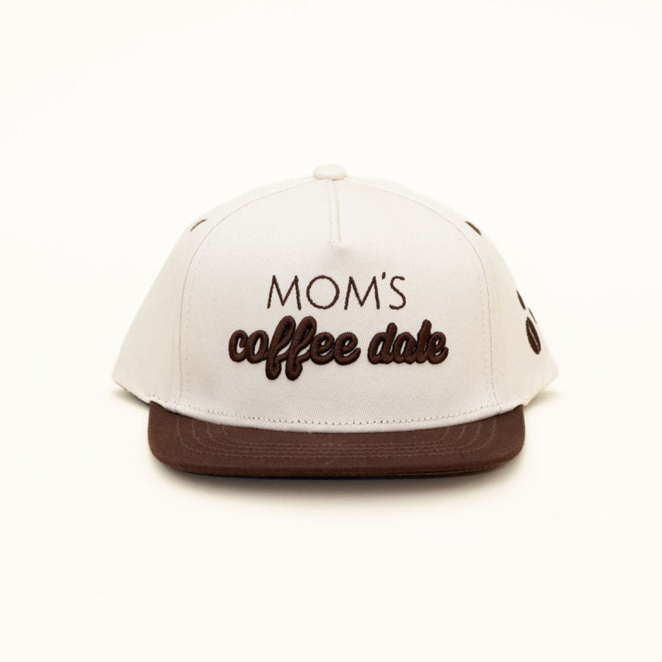 White cap with 'Mom's coffee date' text on a white background