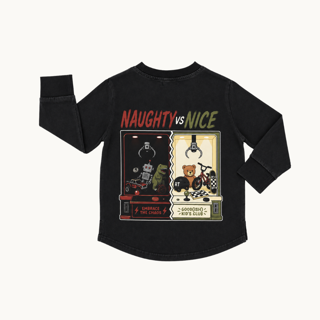 A black long-sleeve t-shirt with a graphic print on the back, featuring the text 'NAUGHTY vs NICE' above two claw machine illustrations, shown on a light off-white background.