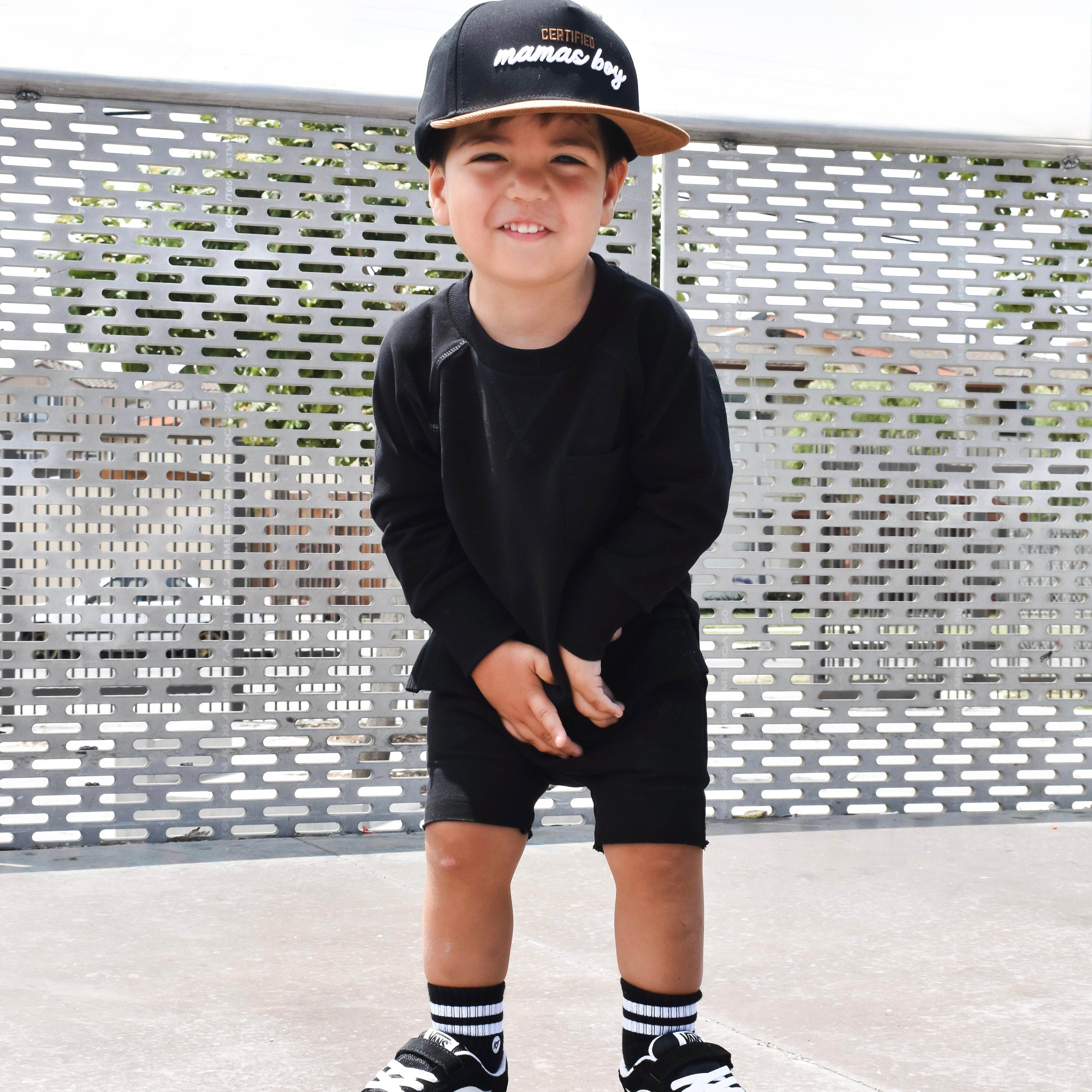 Young boy wearing Onyx Core Collection toddler set, standing outdoors and showcasing the relaxed, above-the-knee fit.