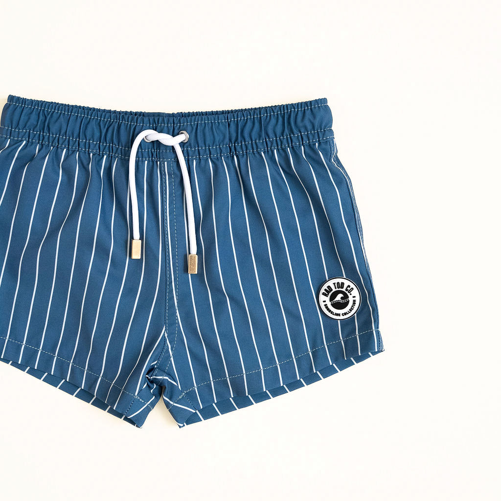 Blue striped shorts with a logo on a white background by rad toddler