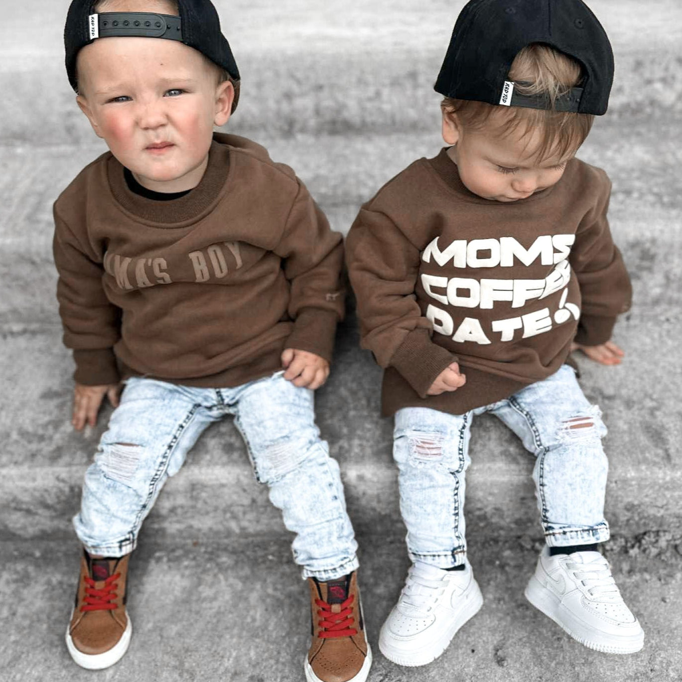 2 boys wearing crewnecks and light wash denim jeans