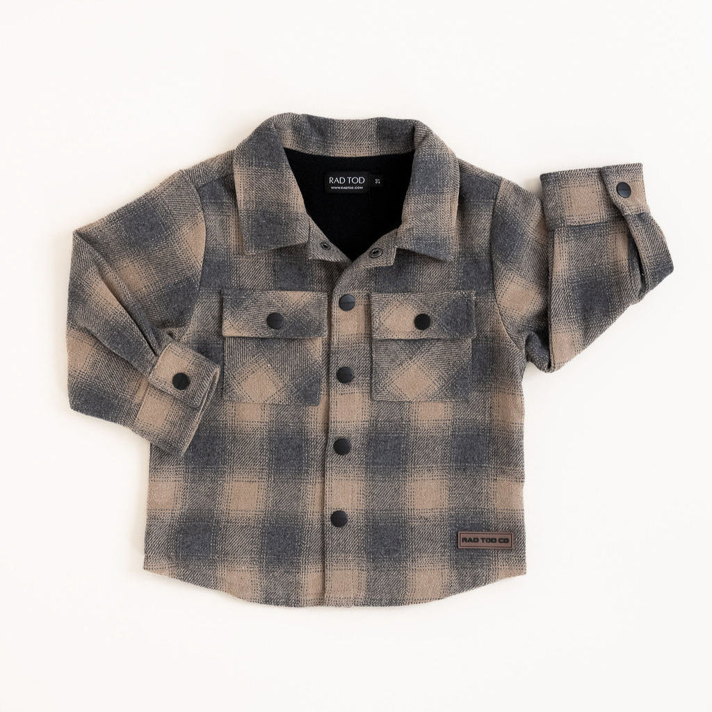 Plaid shirt with button details on a white background