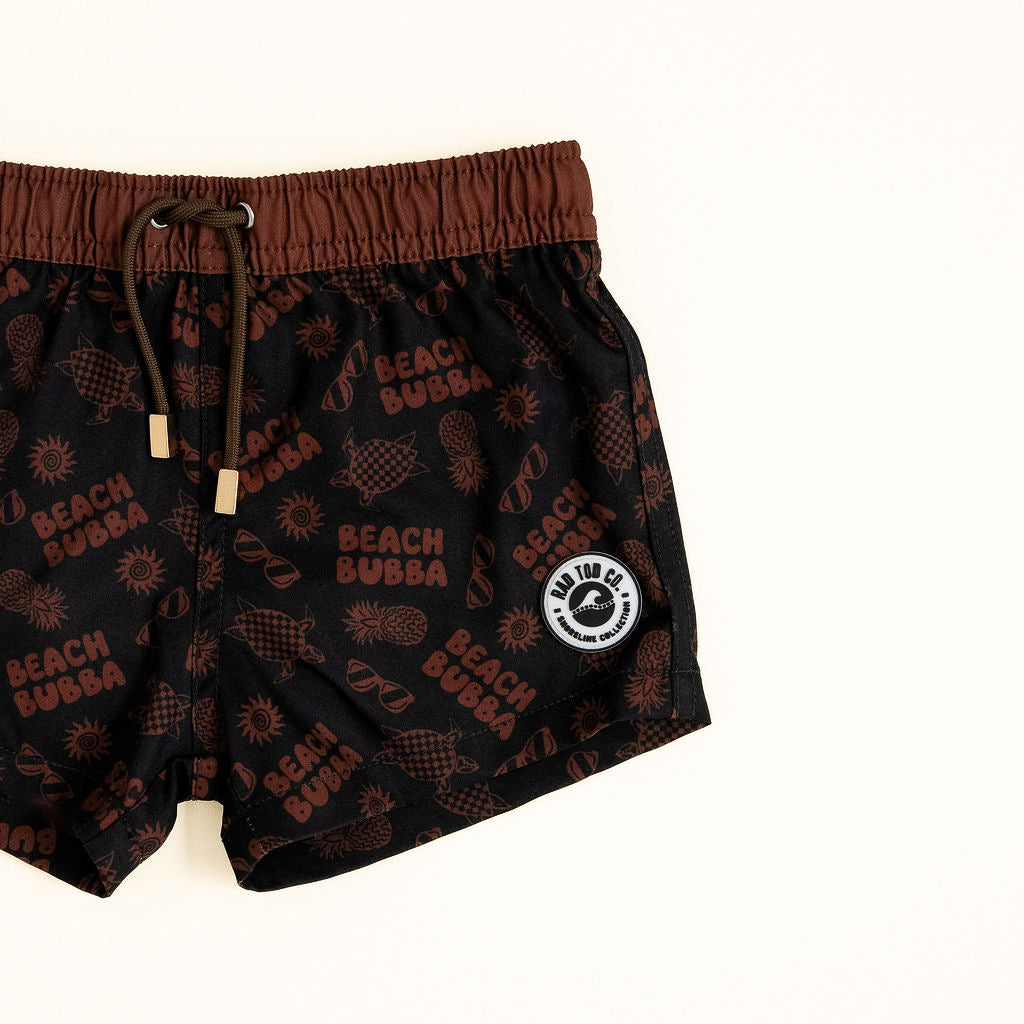 Black swim shorts with brown accents and 'Beach Bubba' branding on a white background