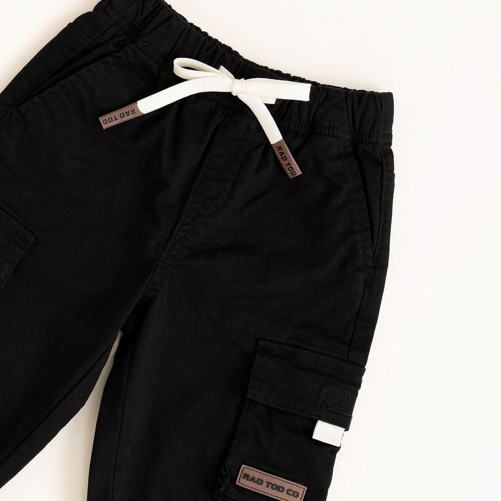 Black cargo pants with white drawstring on a white background