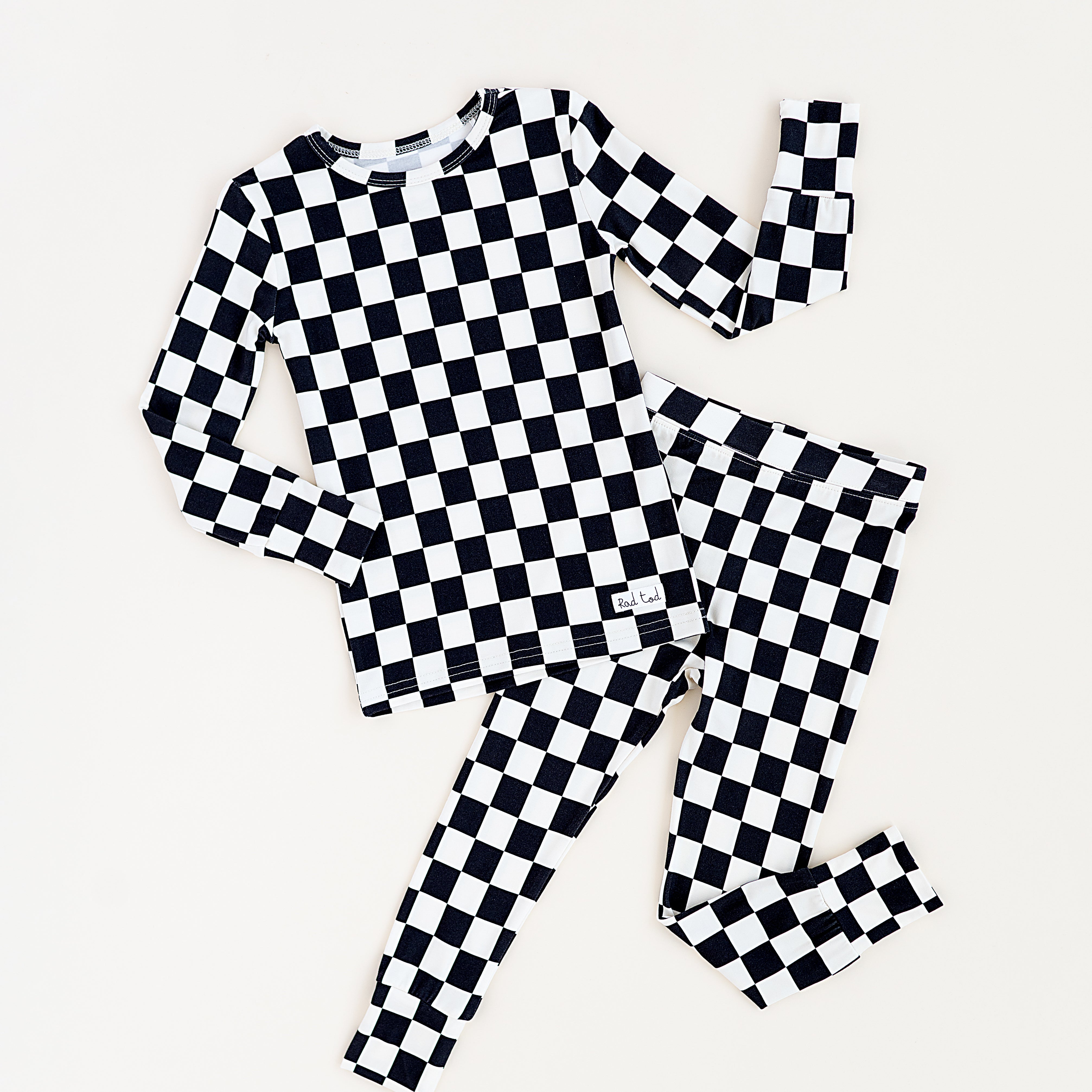 Black checkered 2-piece pajamas for toddlers and kids, featuring a comfy fit and elastic waistband by Rad Toddler.