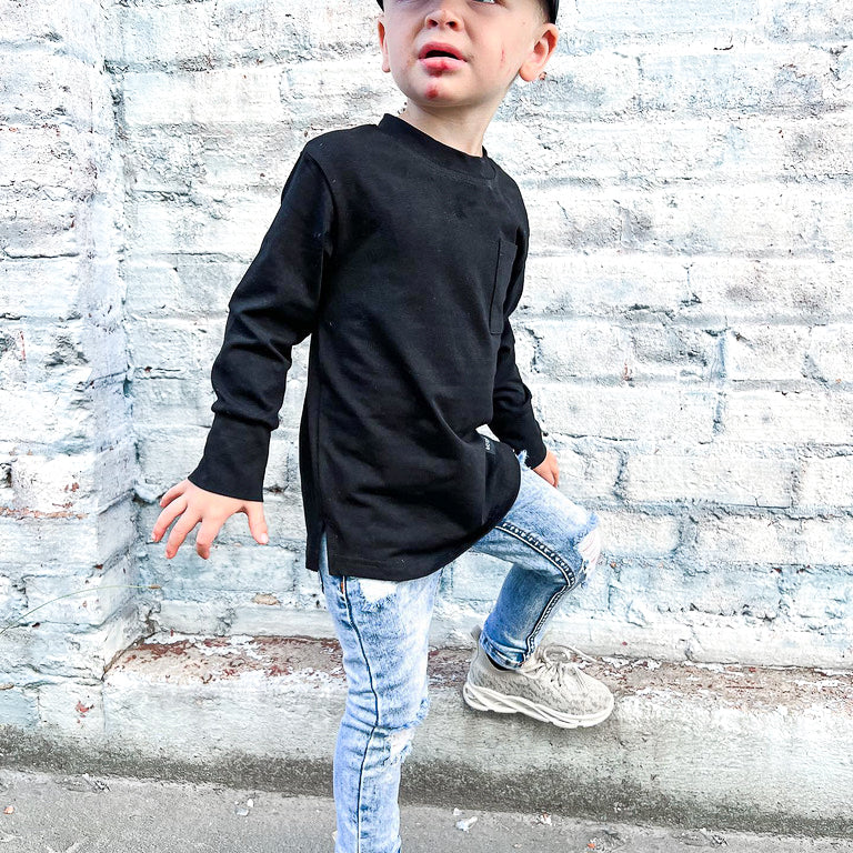boy wearing black long sleeve tee with a black hat and some cool jeans