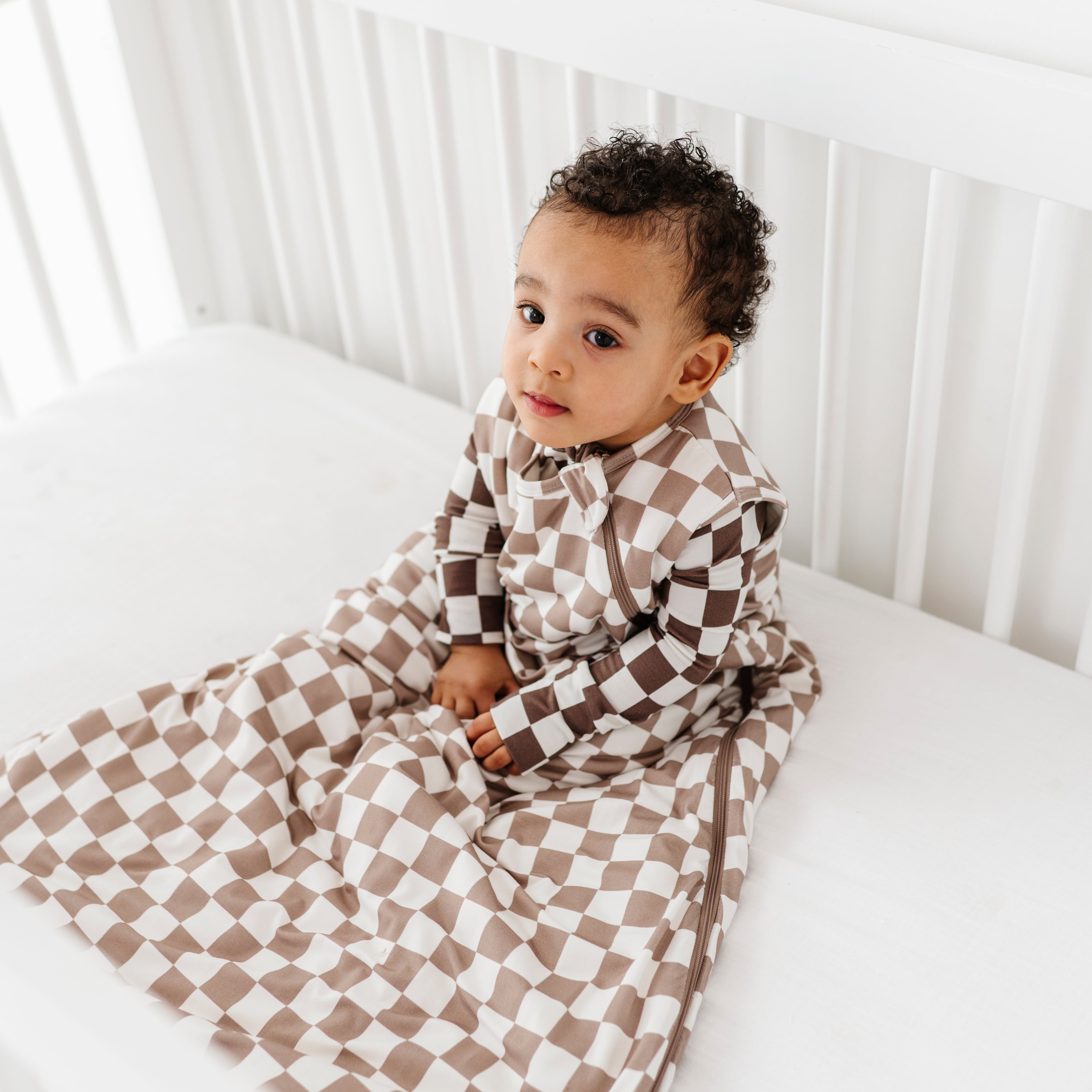 boy wearing Bamboo sleep bag for toddlers aged 6 months to 3 years, featuring soft fabric and a two-way zipper by Rad Toddler.