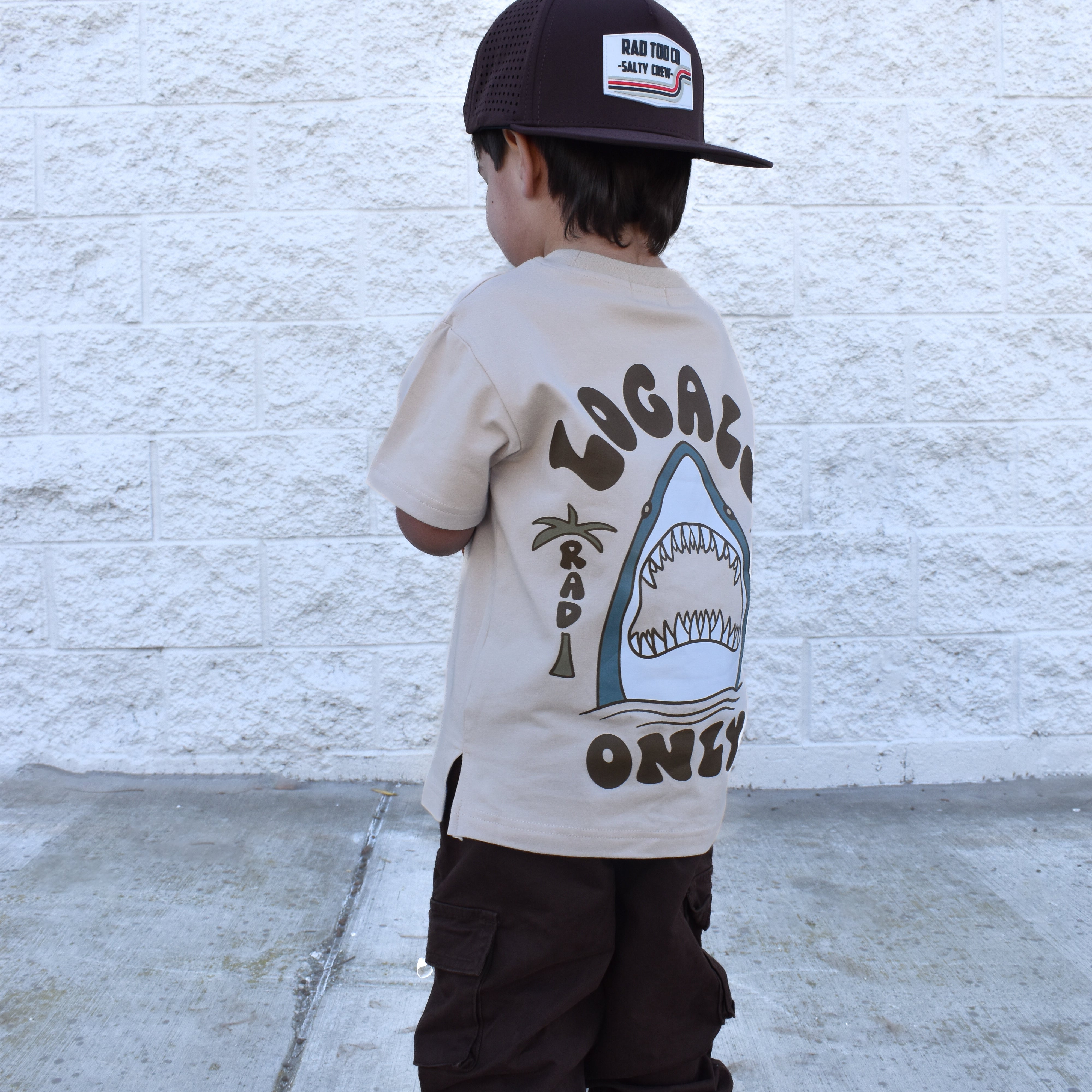 Cool kid wearing beige Locals Only shark t-shirt, everyday kids street style