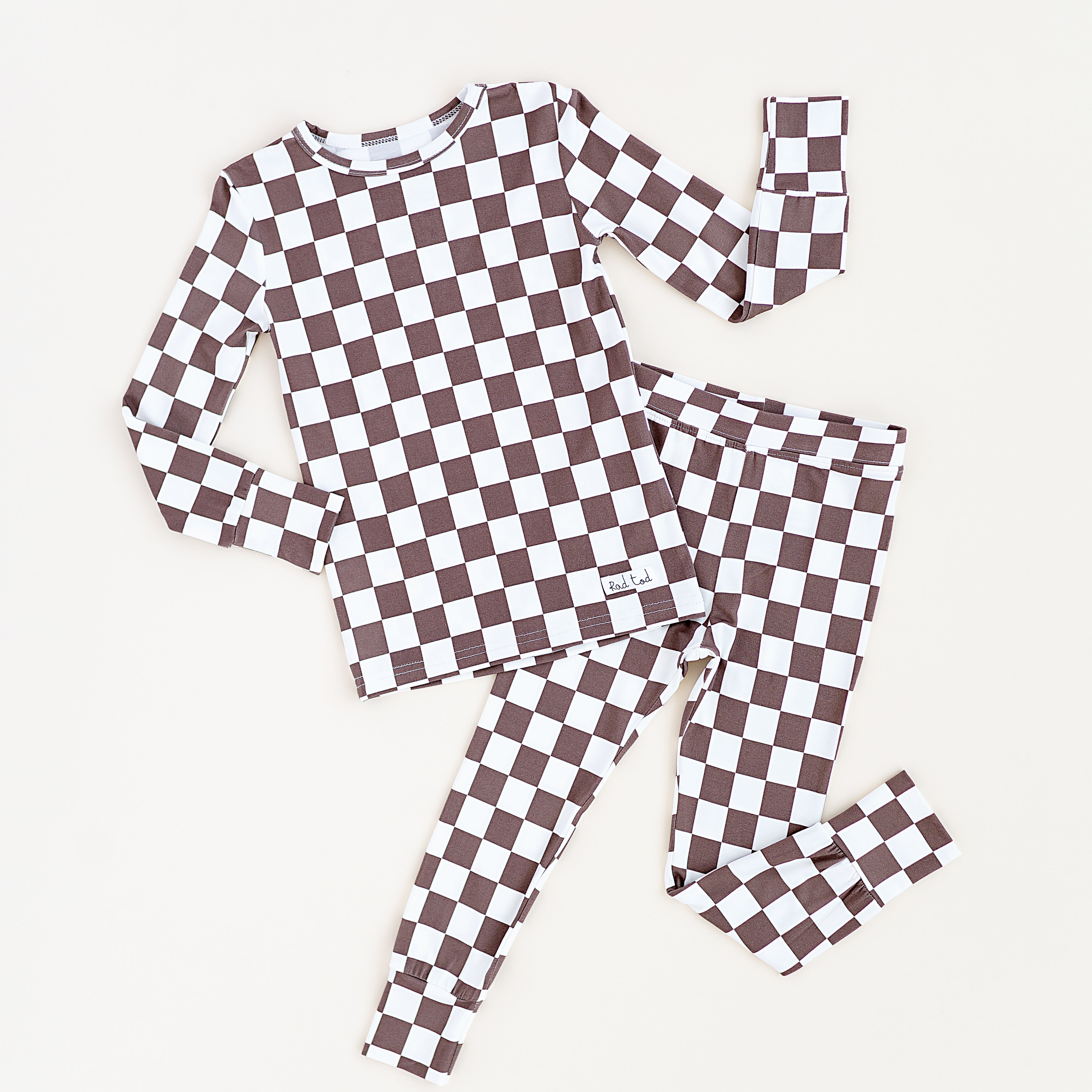Bronze and white checkered bamboo 2-piece pajama set for toddlers, featuring a short sleeve top and elastic waistband pants by Rad Toddler.