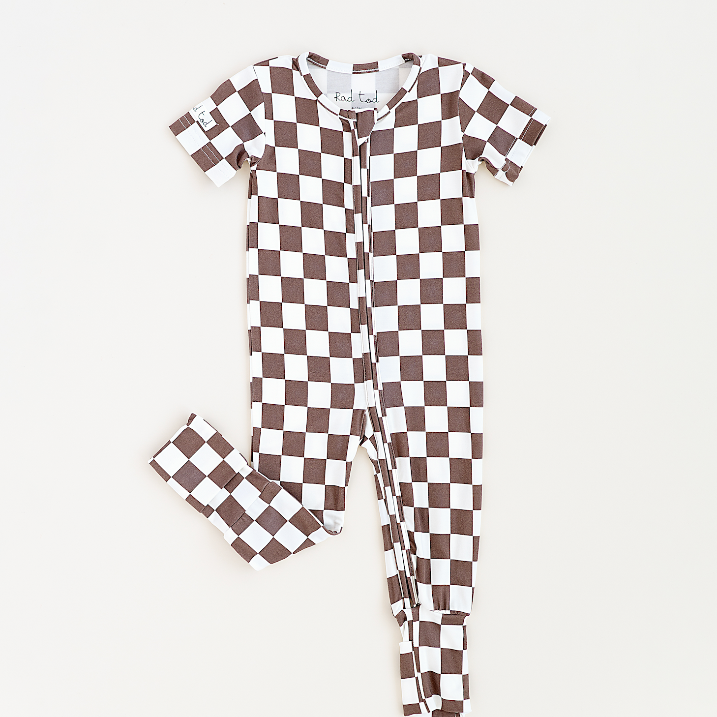 Bronze and white checkered bamboo onesie for toddlers, featuring a two-way zipper and optional foldover footies by Rad Toddler.
