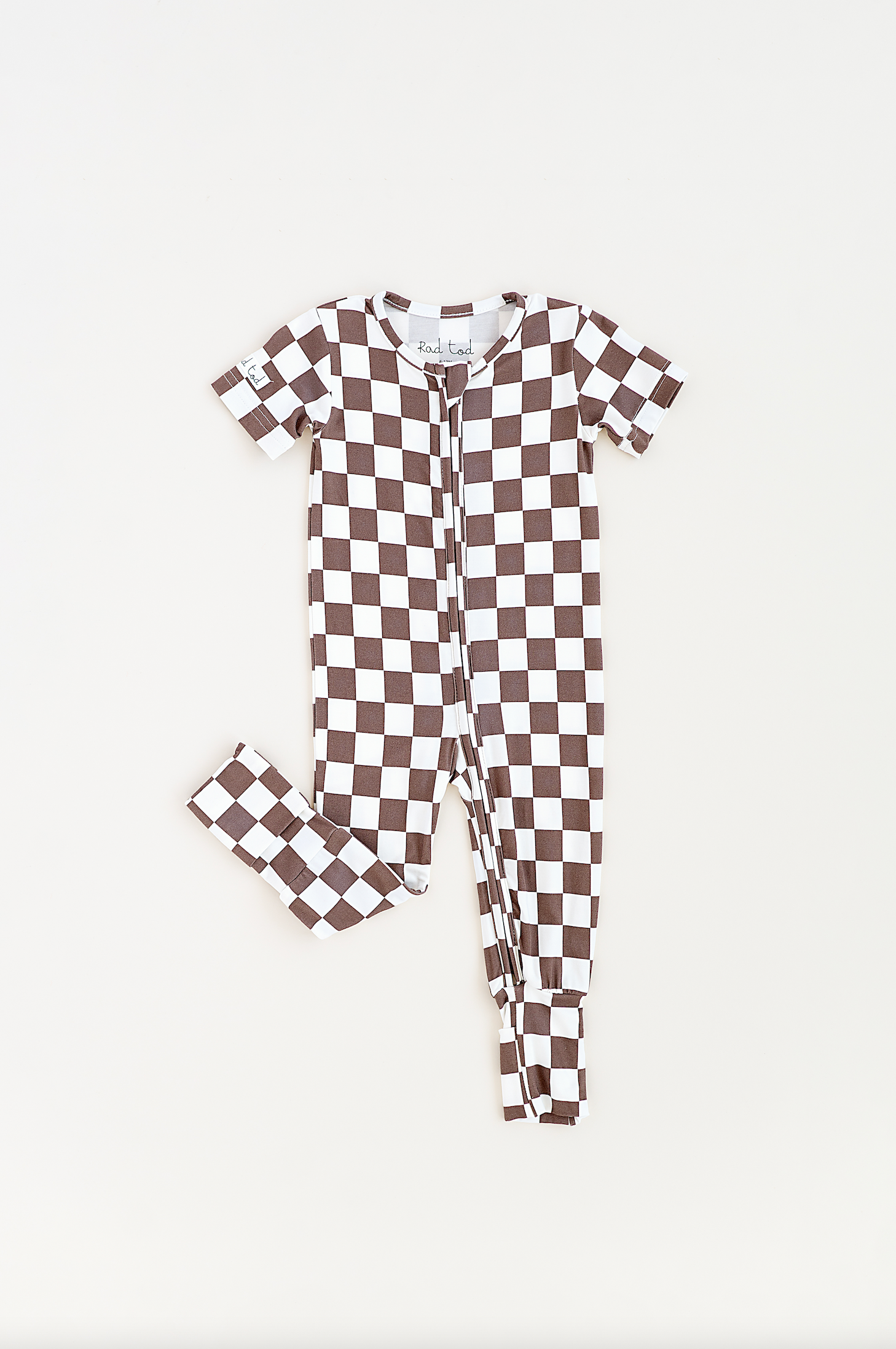 Bronze and white checkered bamboo onesie for toddlers, featuring a two-way zipper and optional foldover footies by Rad Toddler.