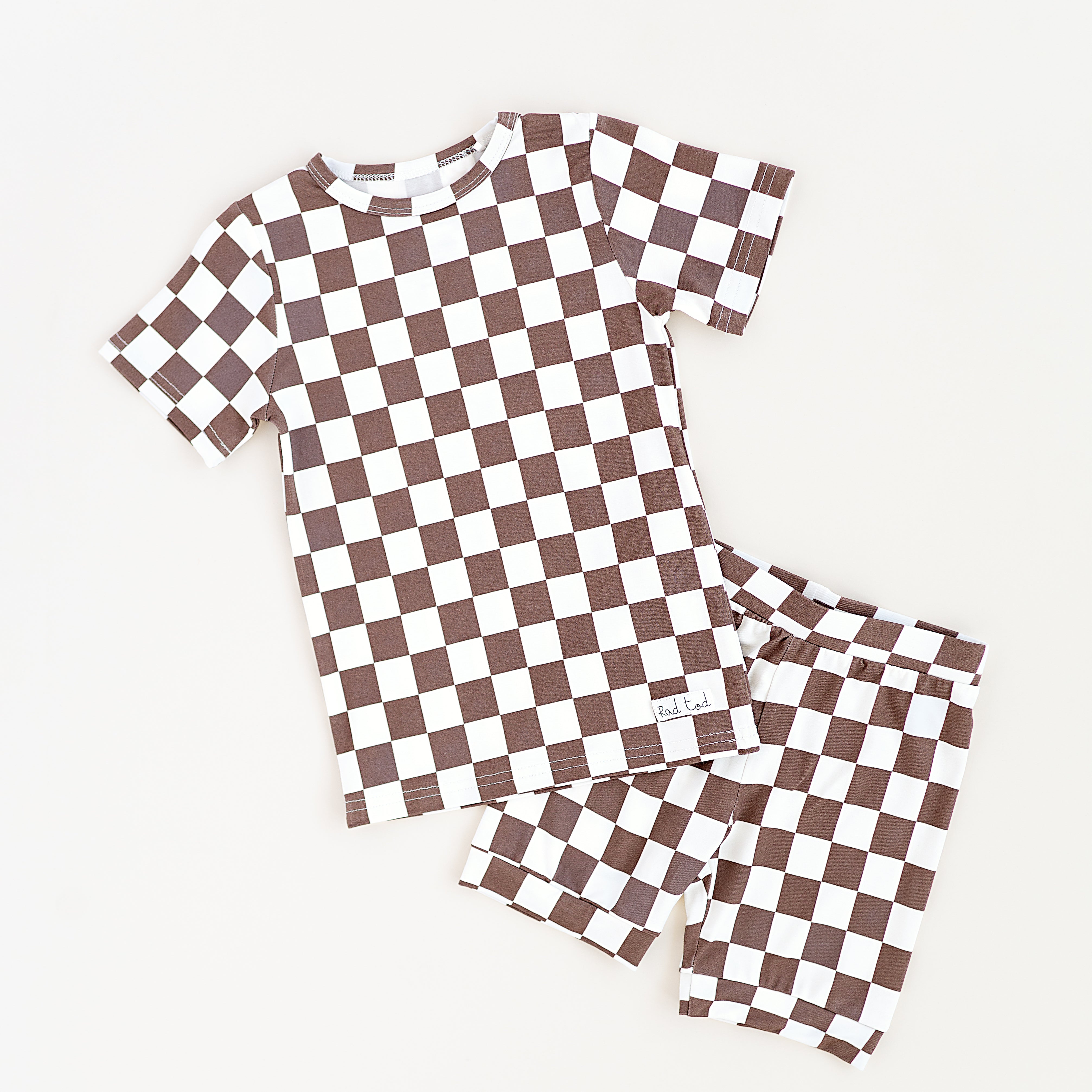 Bronze and white checkered bamboo short sleeve pajama set for toddlers, featuring soft, breathable fabric and a stretchy waistband by Rad Toddler.