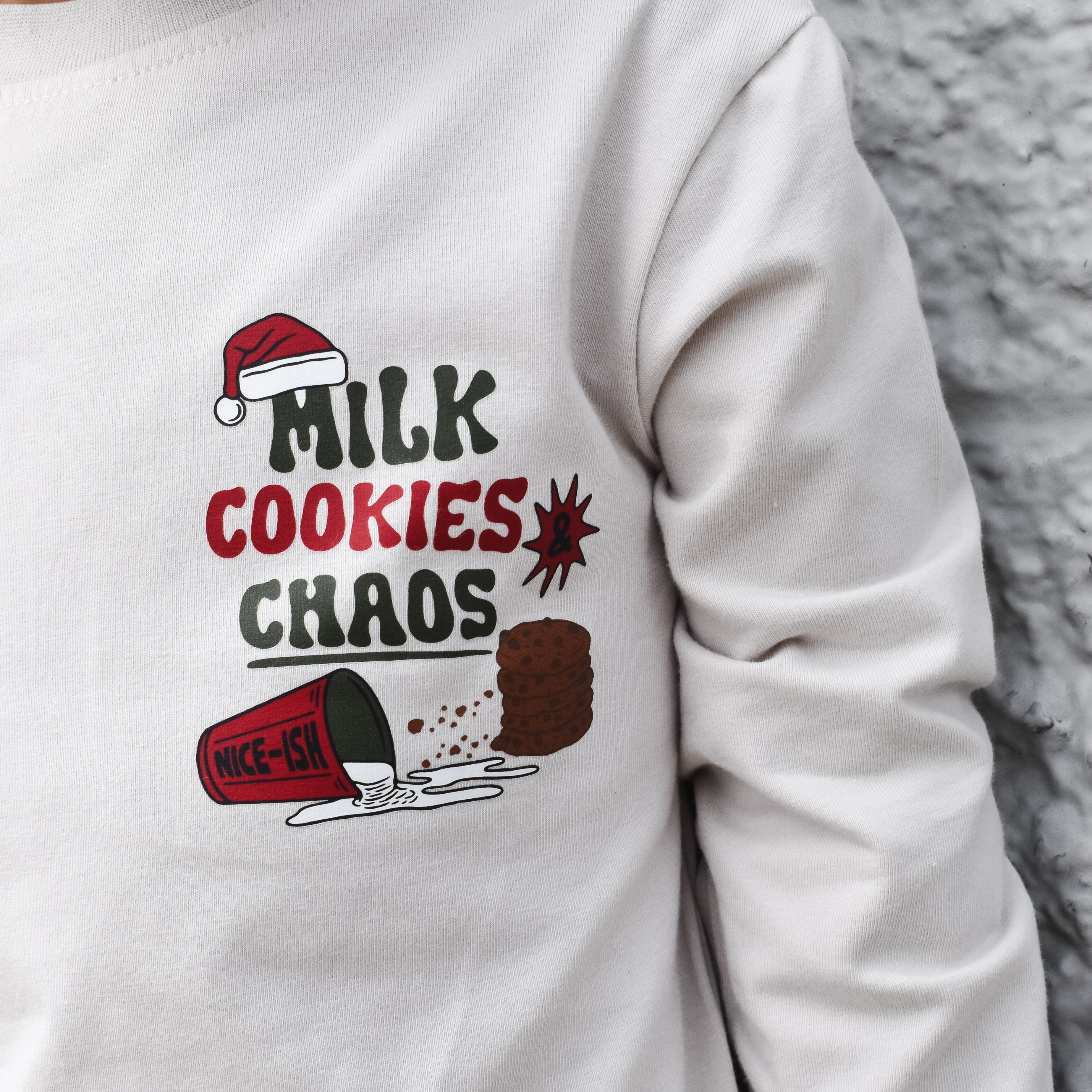 Front view of beige Milk, Cookies & Chaos Christmas long sleeve shirtbackground