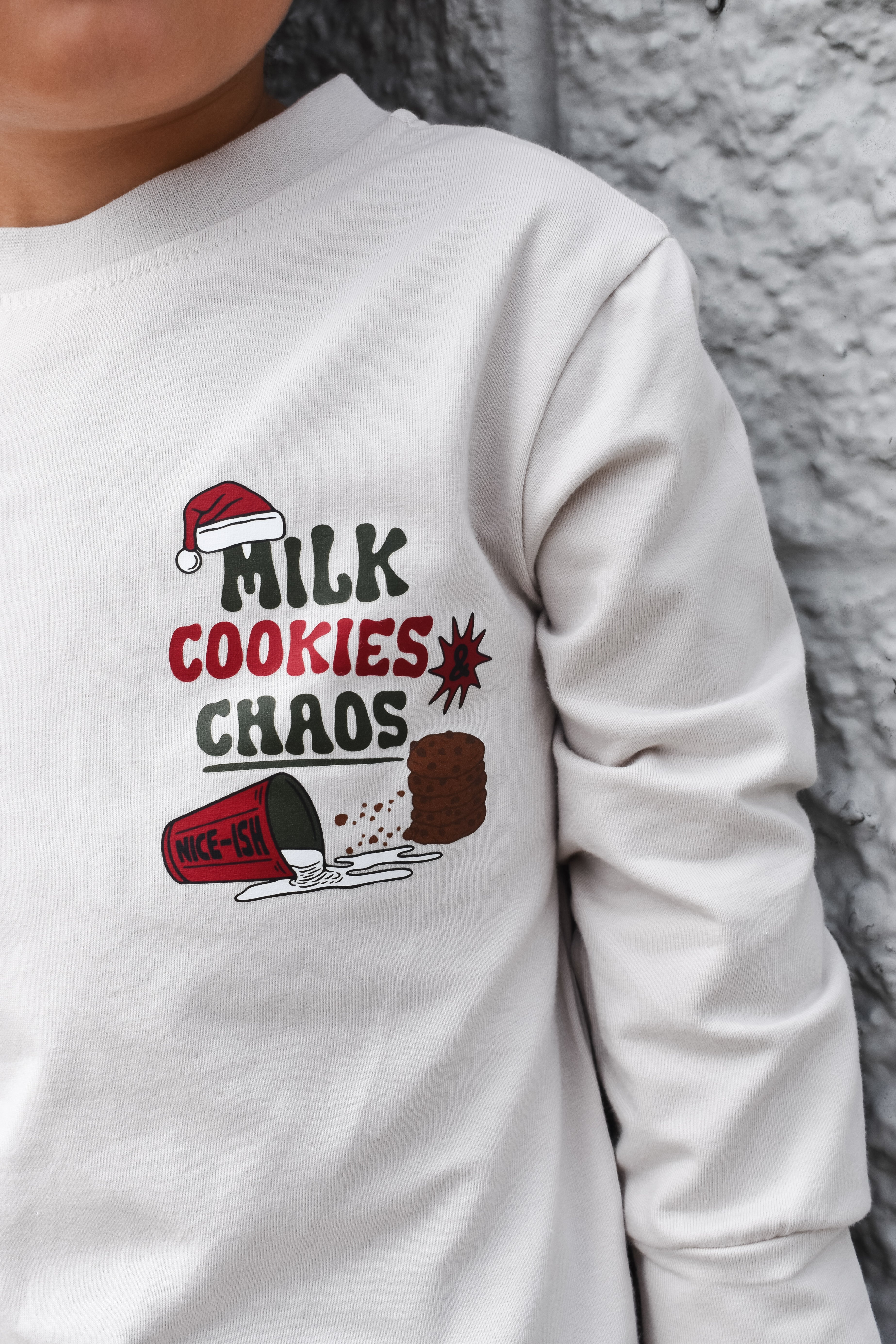 Front view of beige Milk, Cookies & Chaos Christmas long sleeve shirtbackground