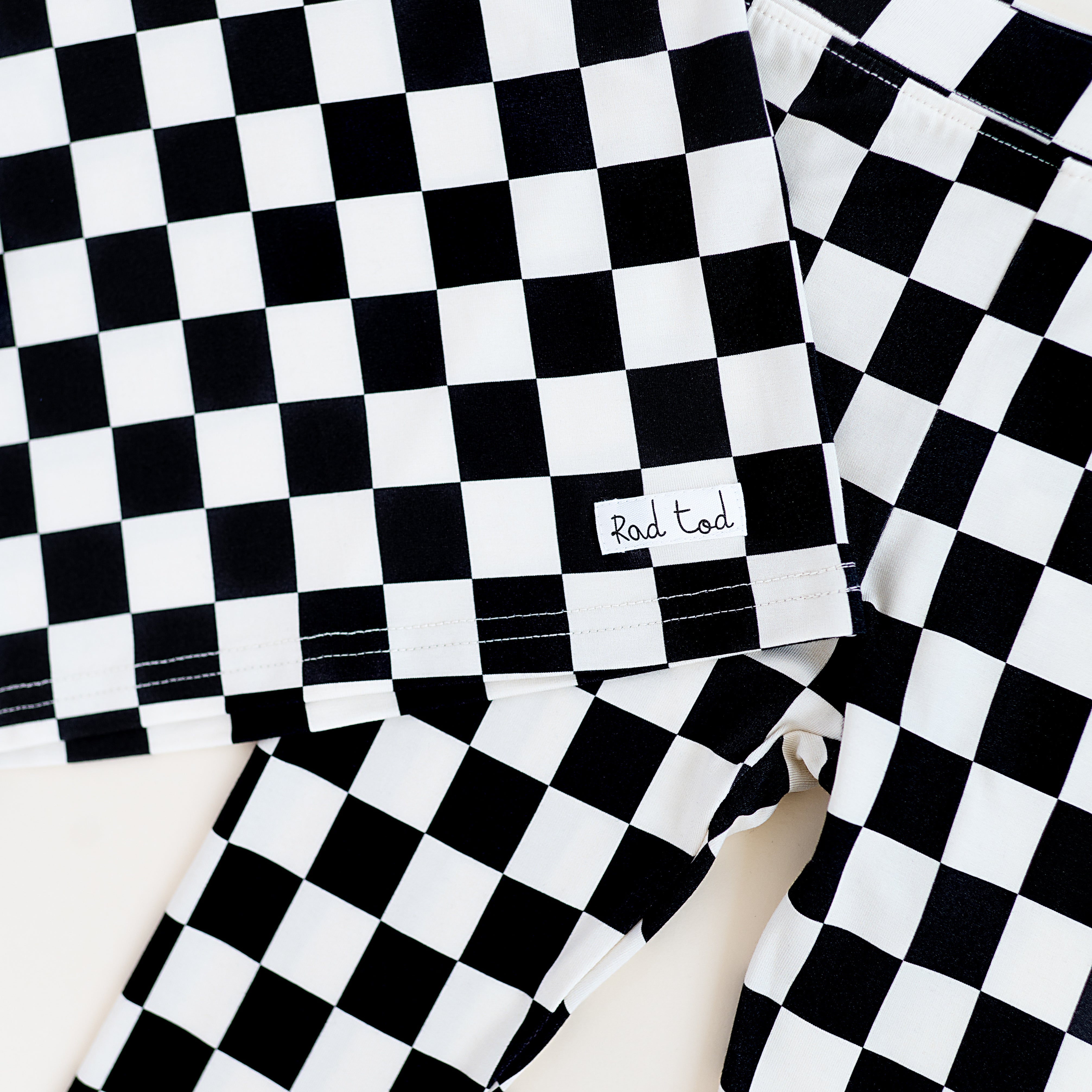 details on Black checkered 2-piece pajamas for toddlers and kids, featuring a comfy fit and elastic waistband by Rad Toddler.