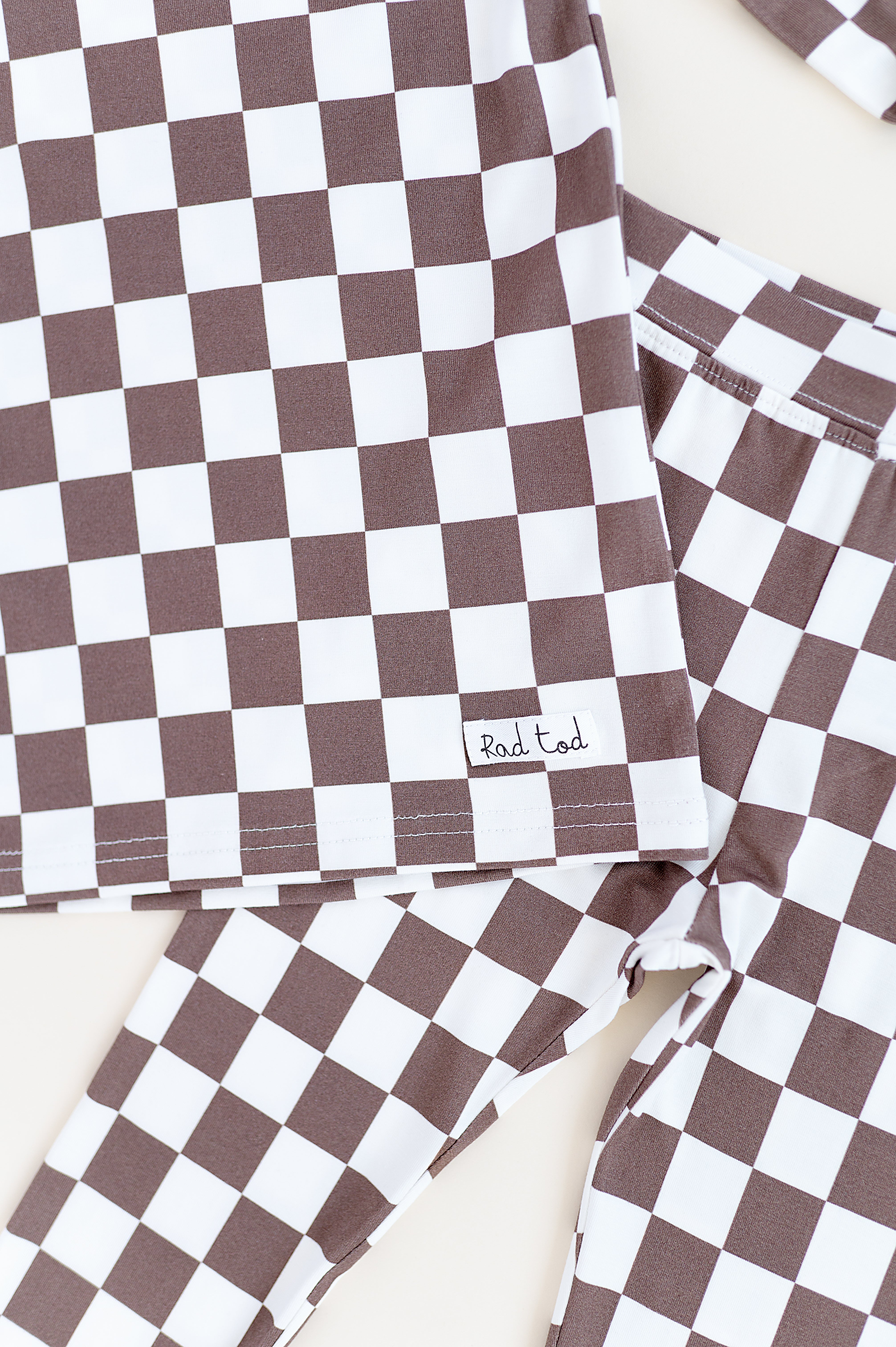 details on Bronze and white checkered bamboo 2-piece pajama set for toddlers, featuring a short sleeve top and elastic waistband pants by Rad Toddler.