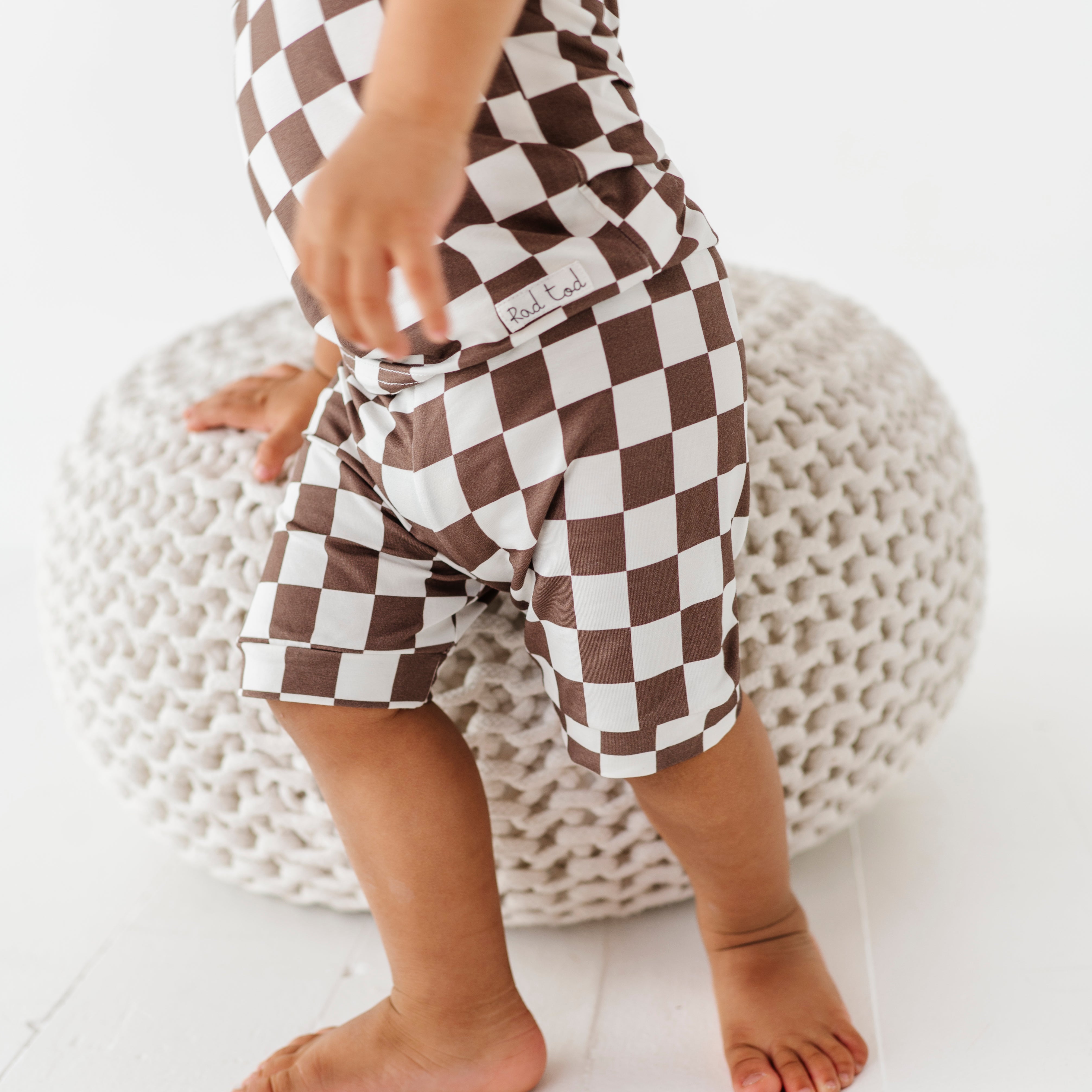 details on Bronze and white checkered bamboo short sleeve pajama set for toddlers, featuring soft, breathable fabric and a stretchy waistband by Rad Toddler.