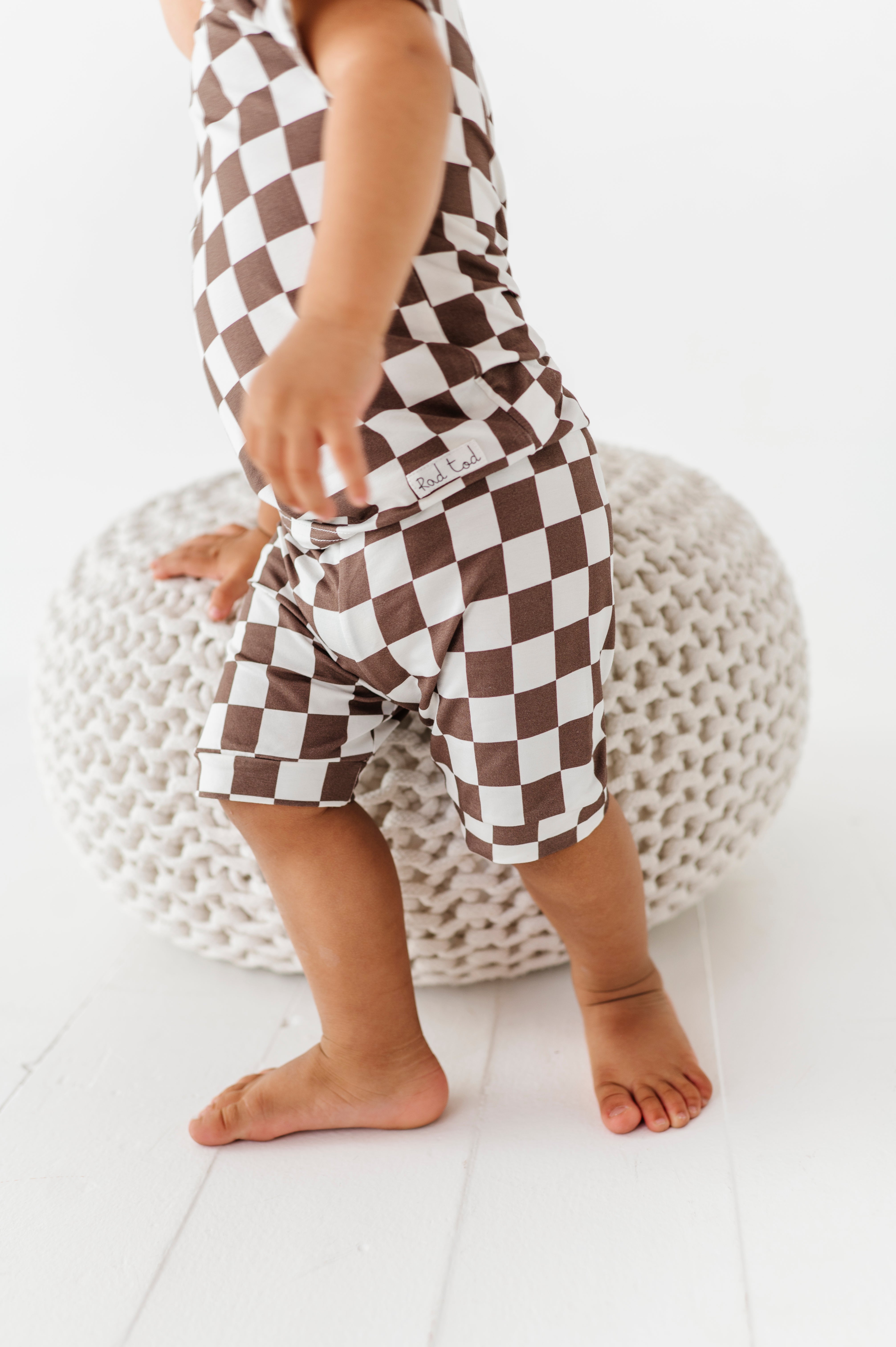 details on Bronze and white checkered bamboo short sleeve pajama set for toddlers, featuring soft, breathable fabric and a stretchy waistband by Rad Toddler.