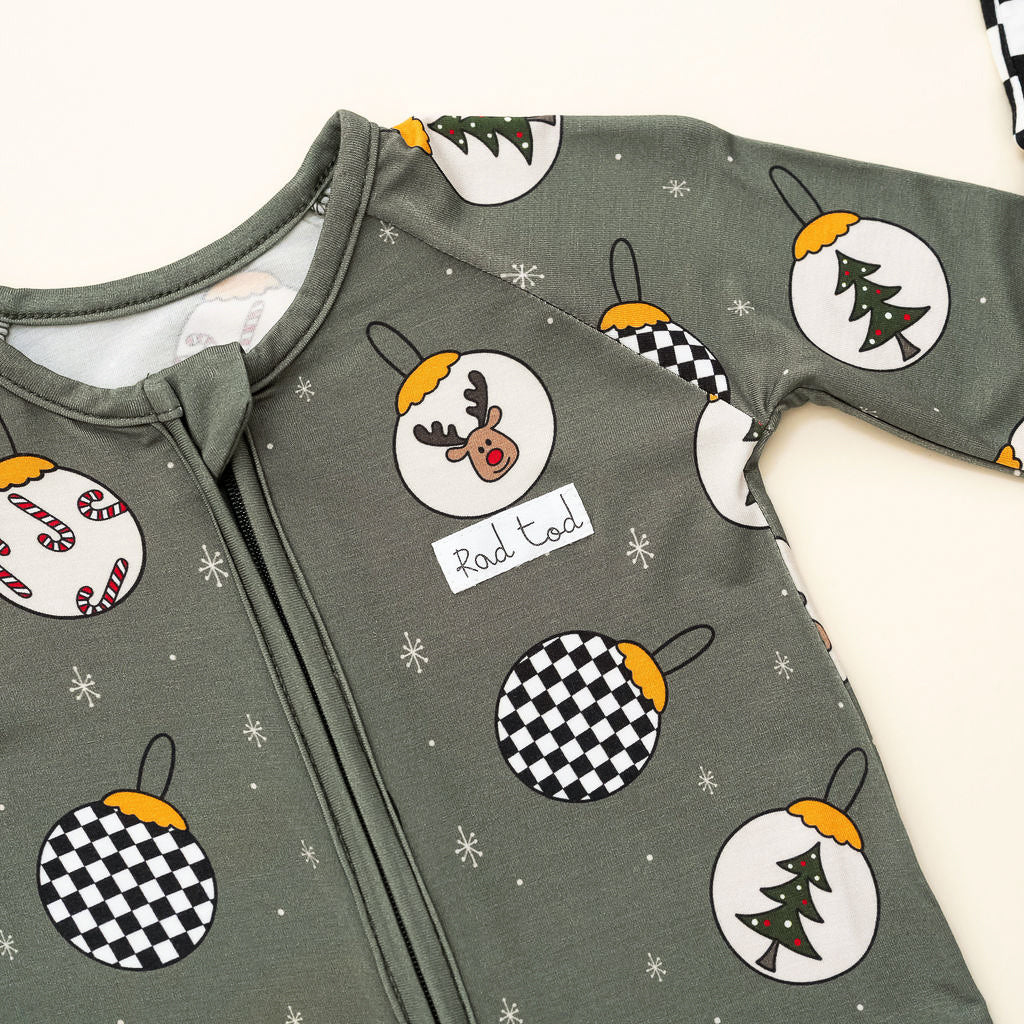 Pine green kids holiday pajamas with festive ornament design close up