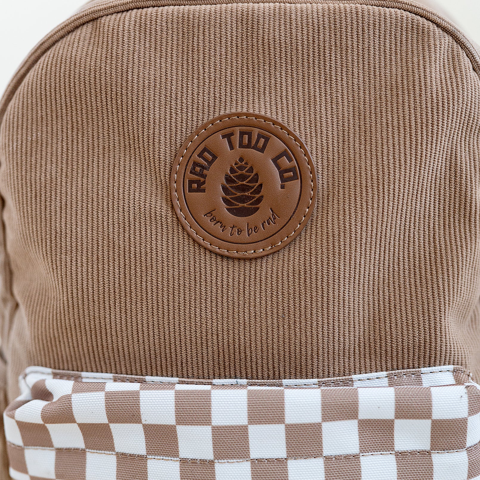 details on the dune toddler backpack with checker patter on pocket