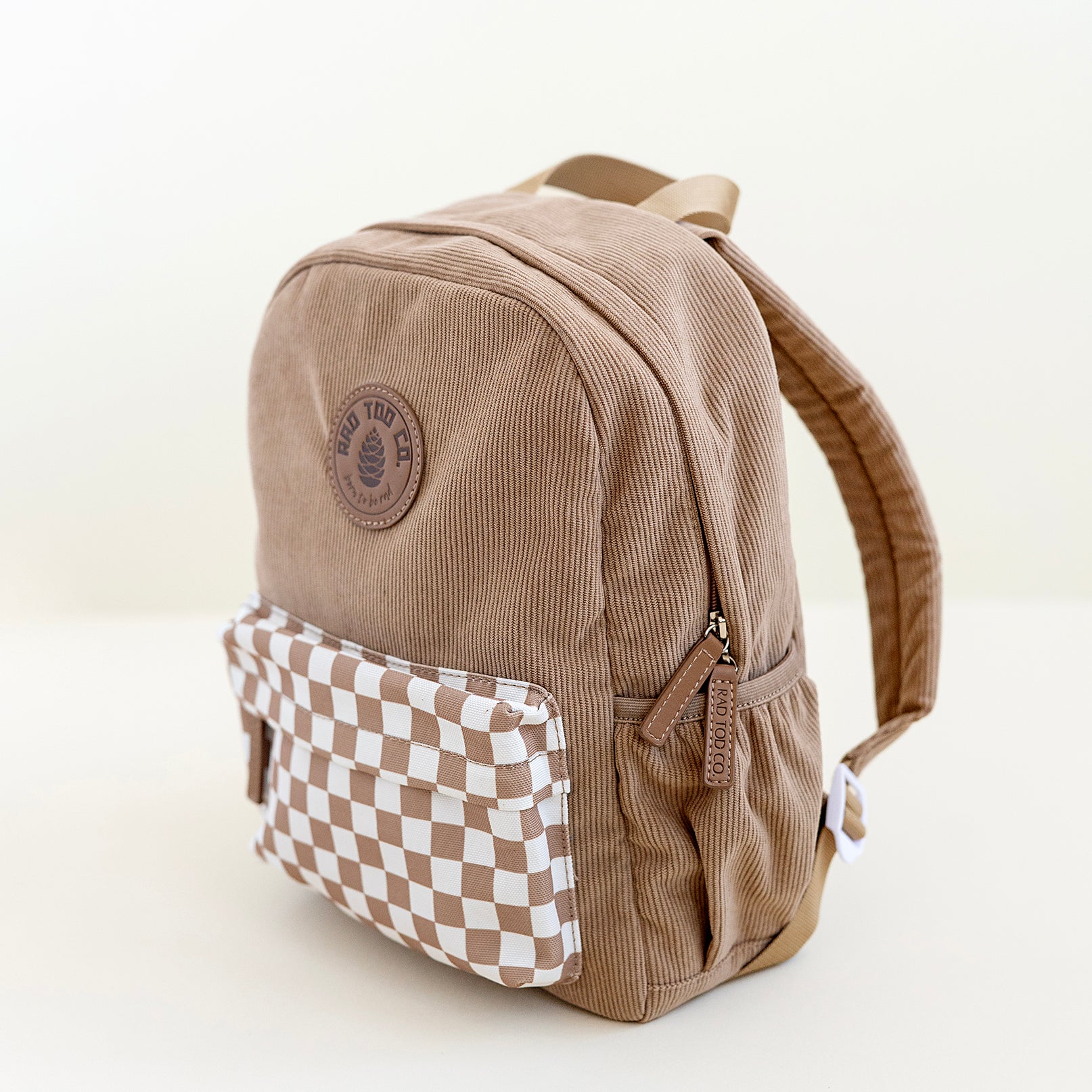 Beige toddler backpack with a stylish checkerboard pattern, perfect for everyday adventures and activities side view