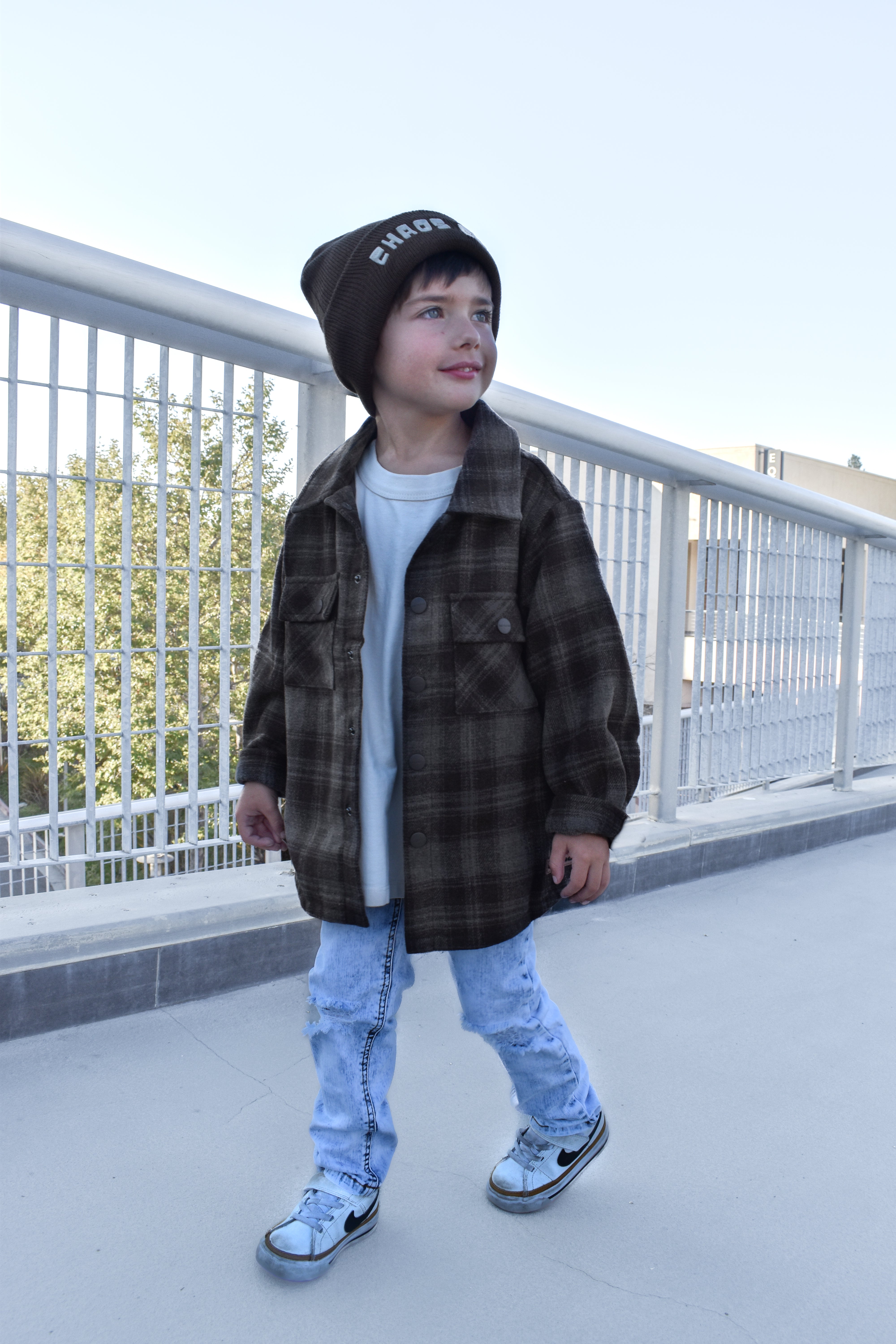 Toddler wearing the Espresso Shacket layered with jeans for a cozy fall look