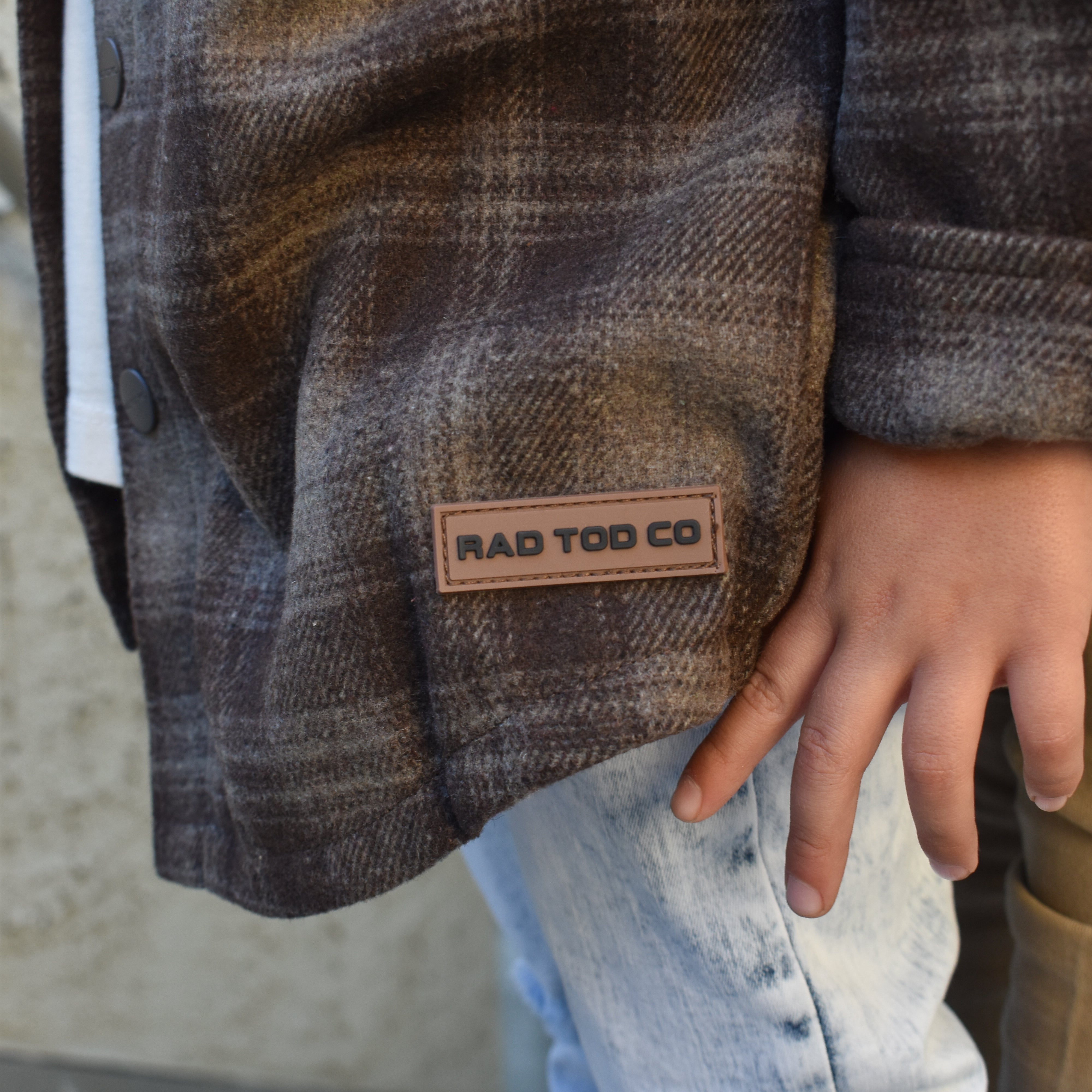 Toddler wearing the Espresso Shacket layered with jeans for a cozy fall look, the details!