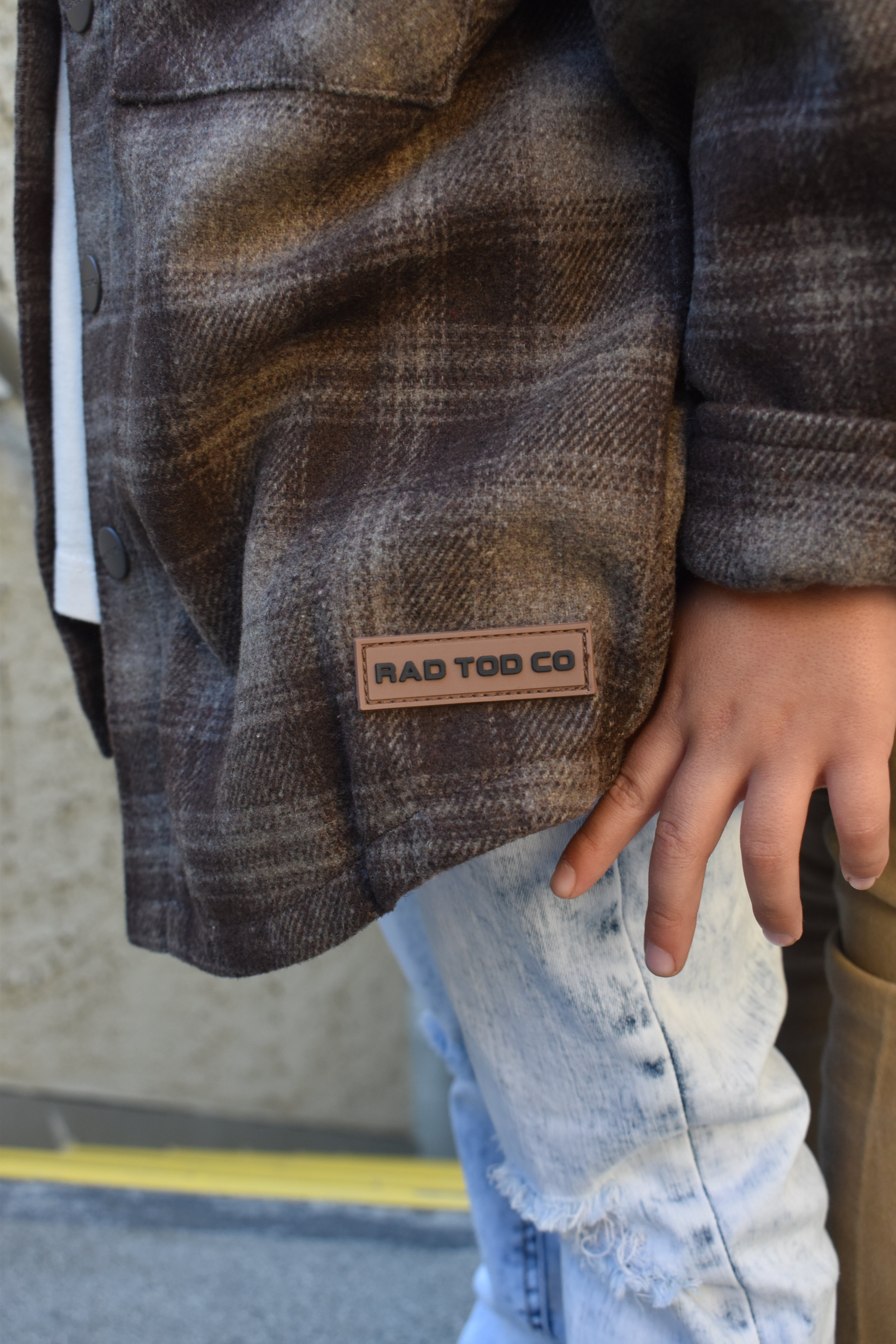 Toddler wearing the Espresso Shacket layered with jeans for a cozy fall look, the details!