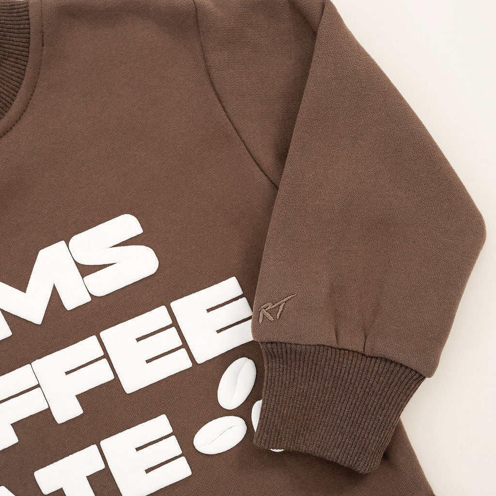 Coffee-brown crewneck with bold off-white “Mom’s Coffee Date” lettering, laid flat on a neutral background.