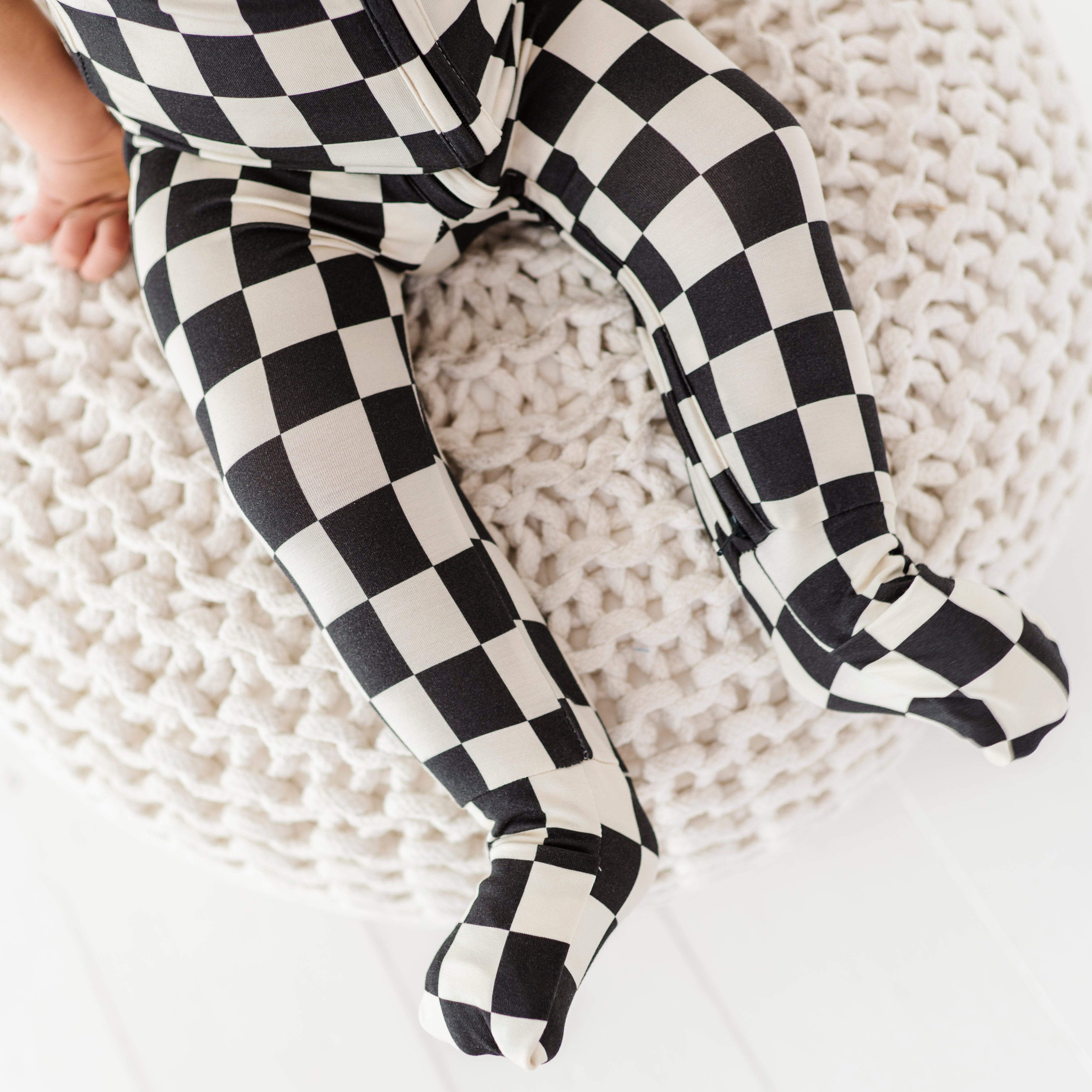 foldover footies on Black and white checkered bamboo short sleeve onesie for toddlers, featuring a two-way zipper and optional foldover footies by Rad Toddler.