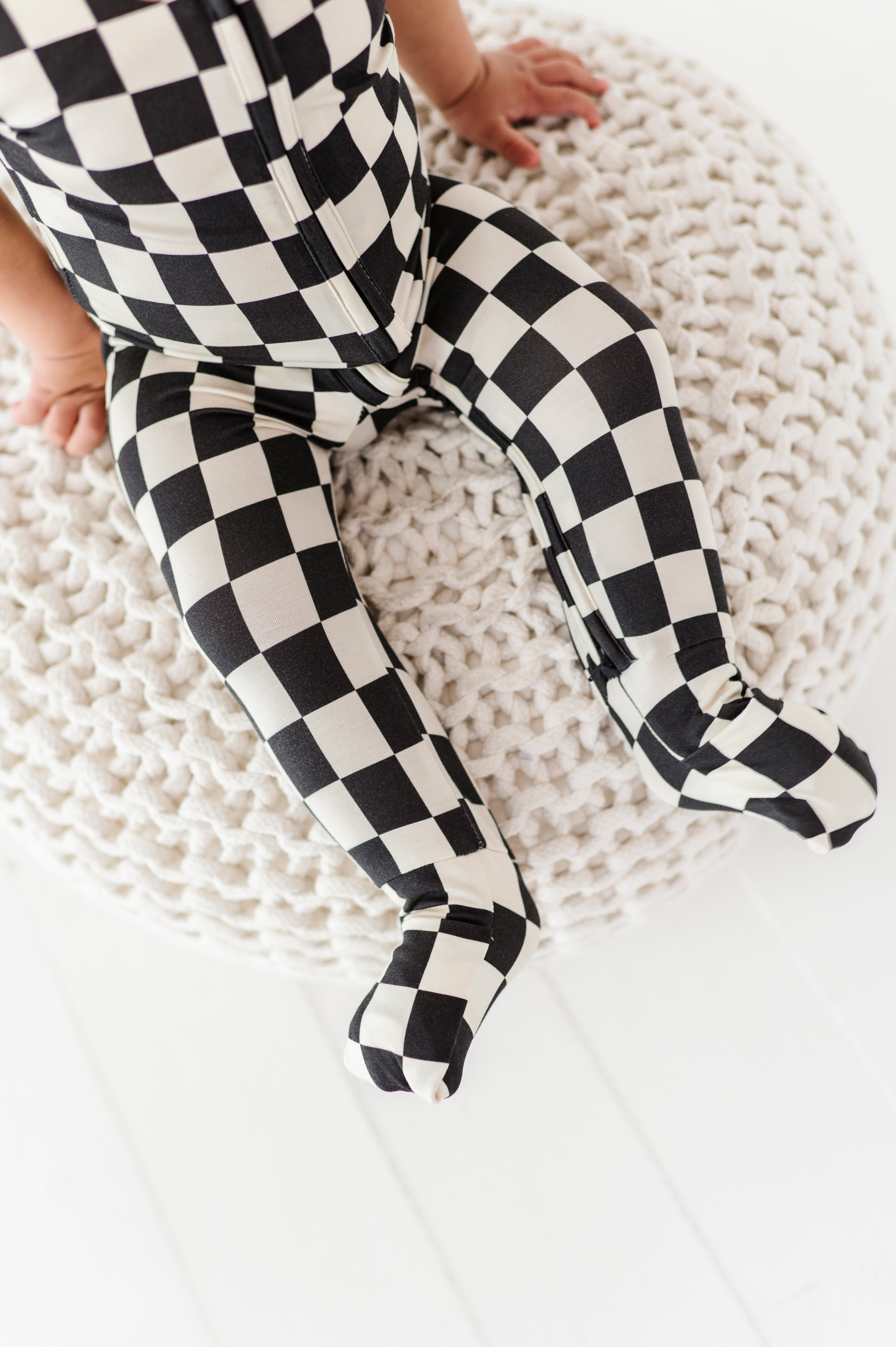 foldover footies on Black and white checkered bamboo short sleeve onesie for toddlers, featuring a two-way zipper and optional foldover footies by Rad Toddler.