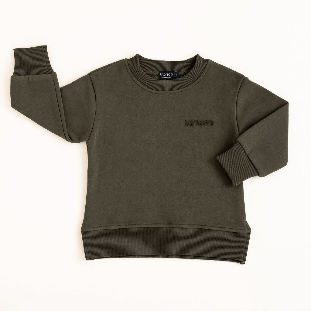 Kids dark green graphic crewneck featuring flaming helmet and skull motif on plain background
