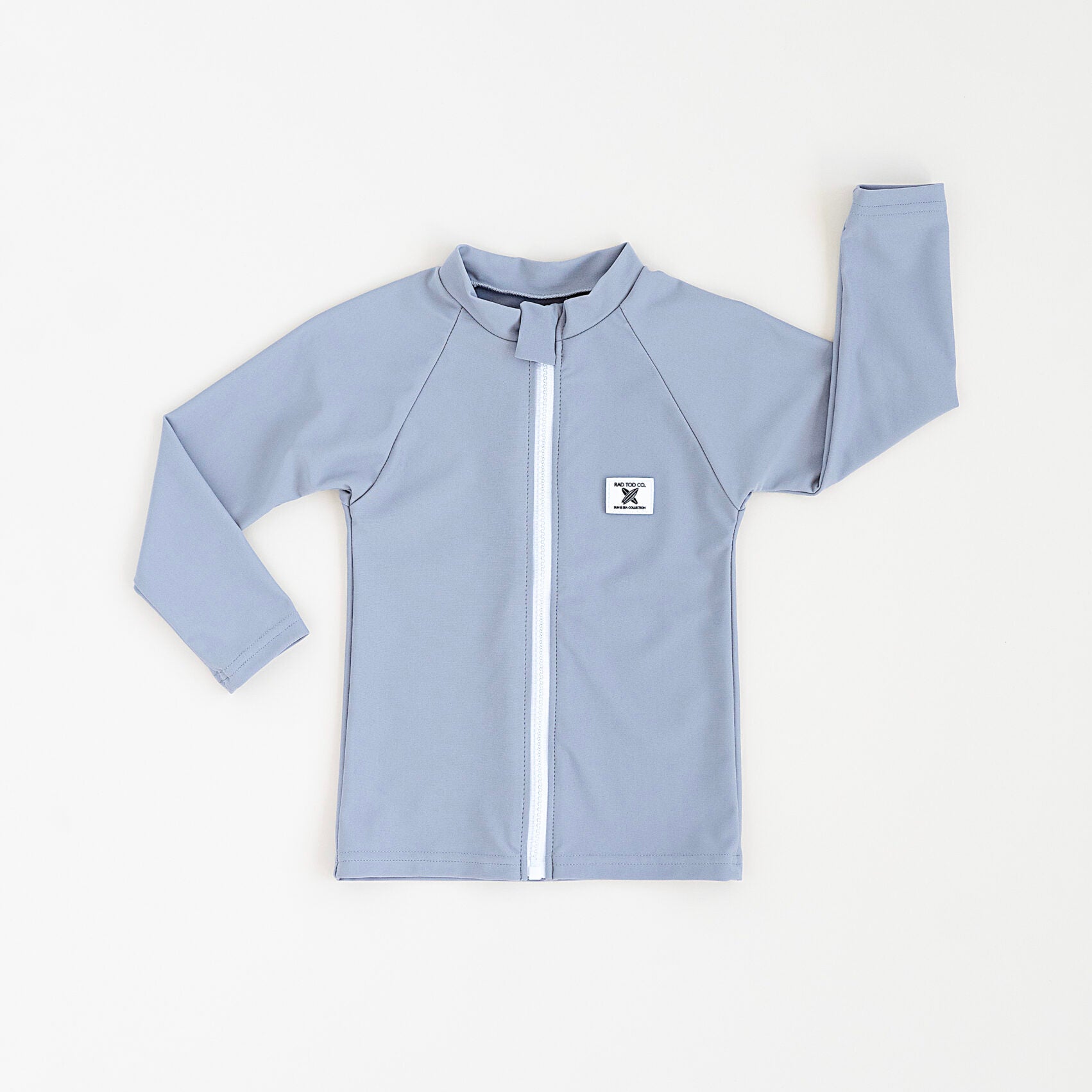 Rad Toddlers gray Rashguard Shirt with front zipper and UPF 50+ protection, perfect for pairing with board shorts for water activities.