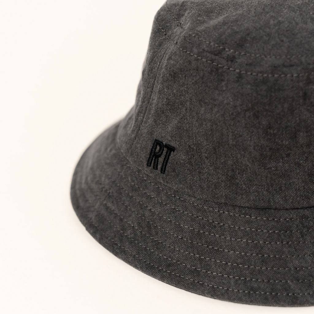 Dark gray bucket hat with a small logo on a white background