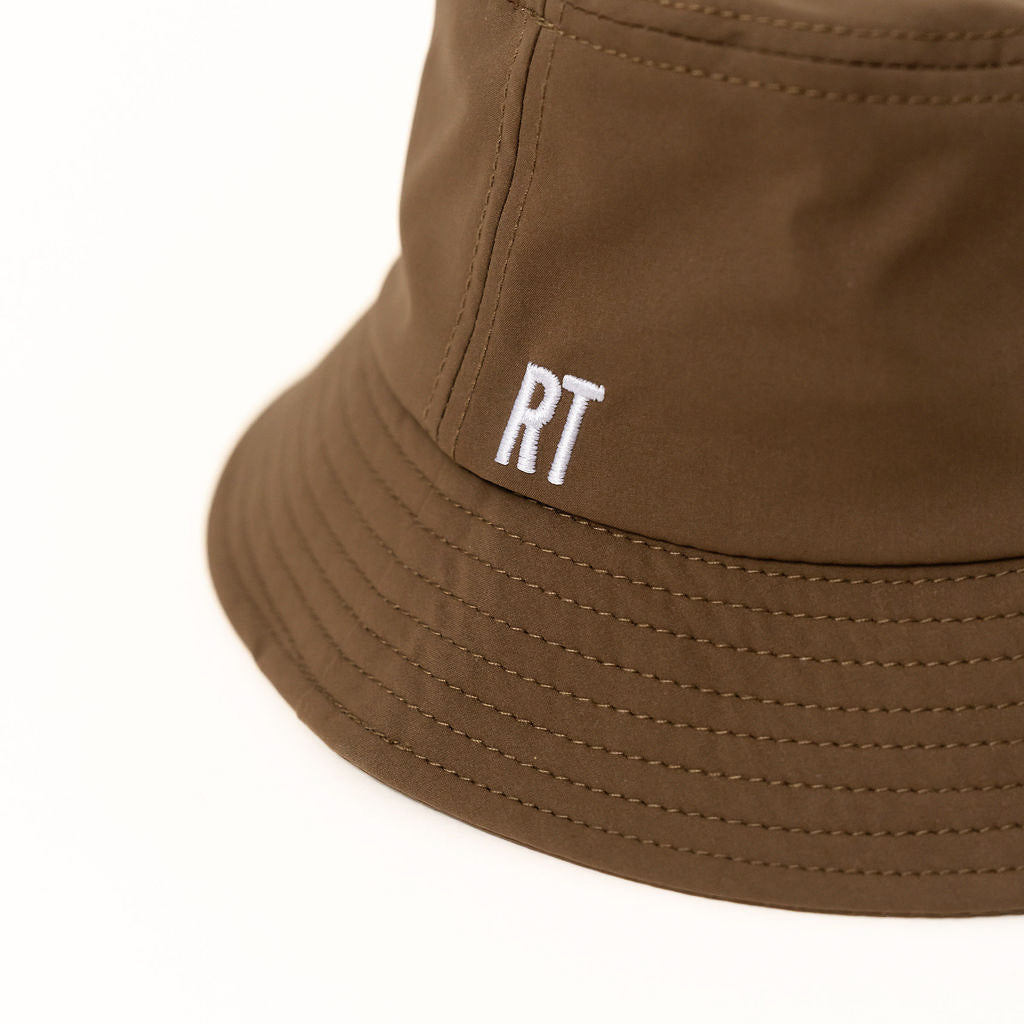 Brown bucket hat with 'RT' logo on a white background