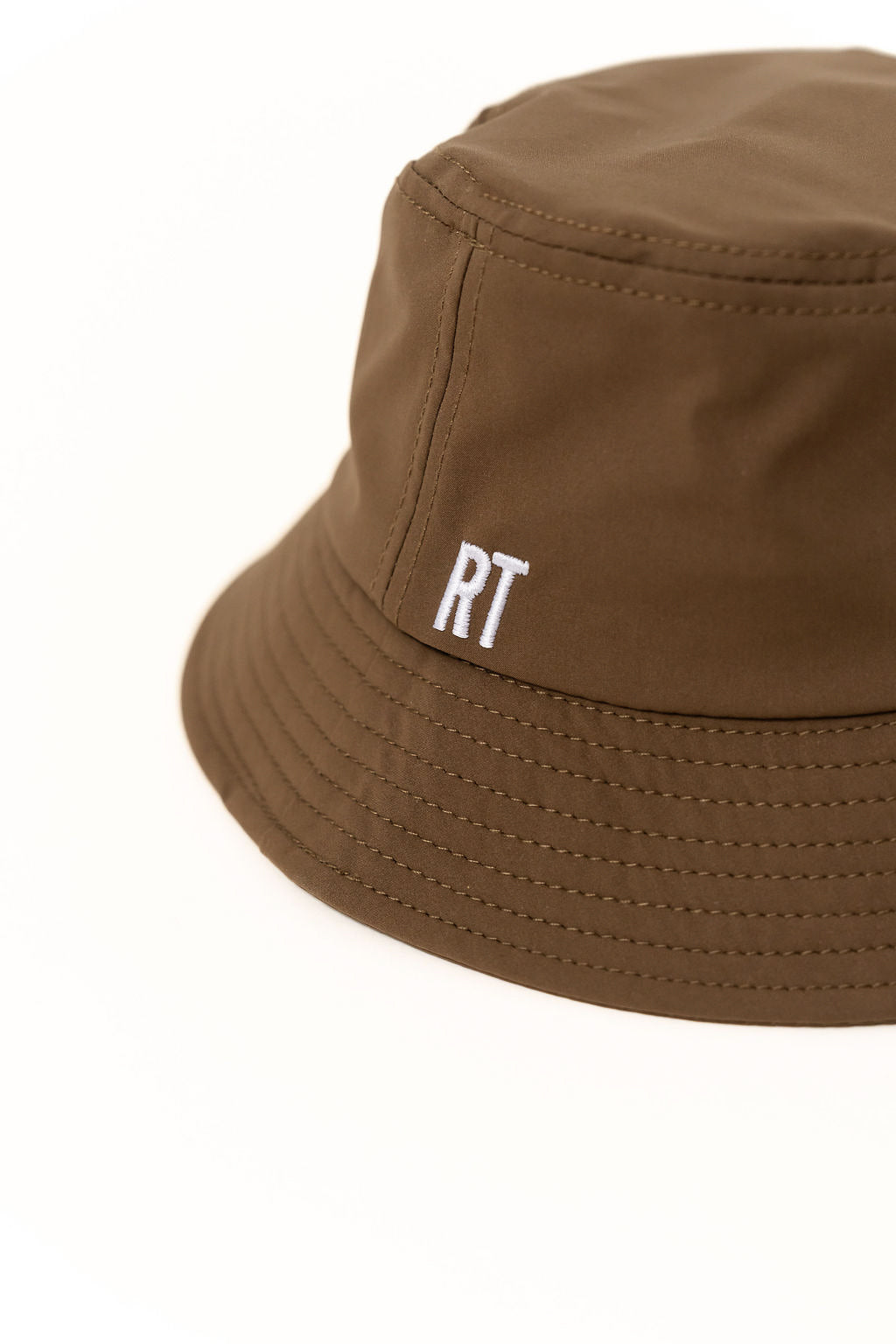 Brown bucket hat with 'RT' logo on a white background
